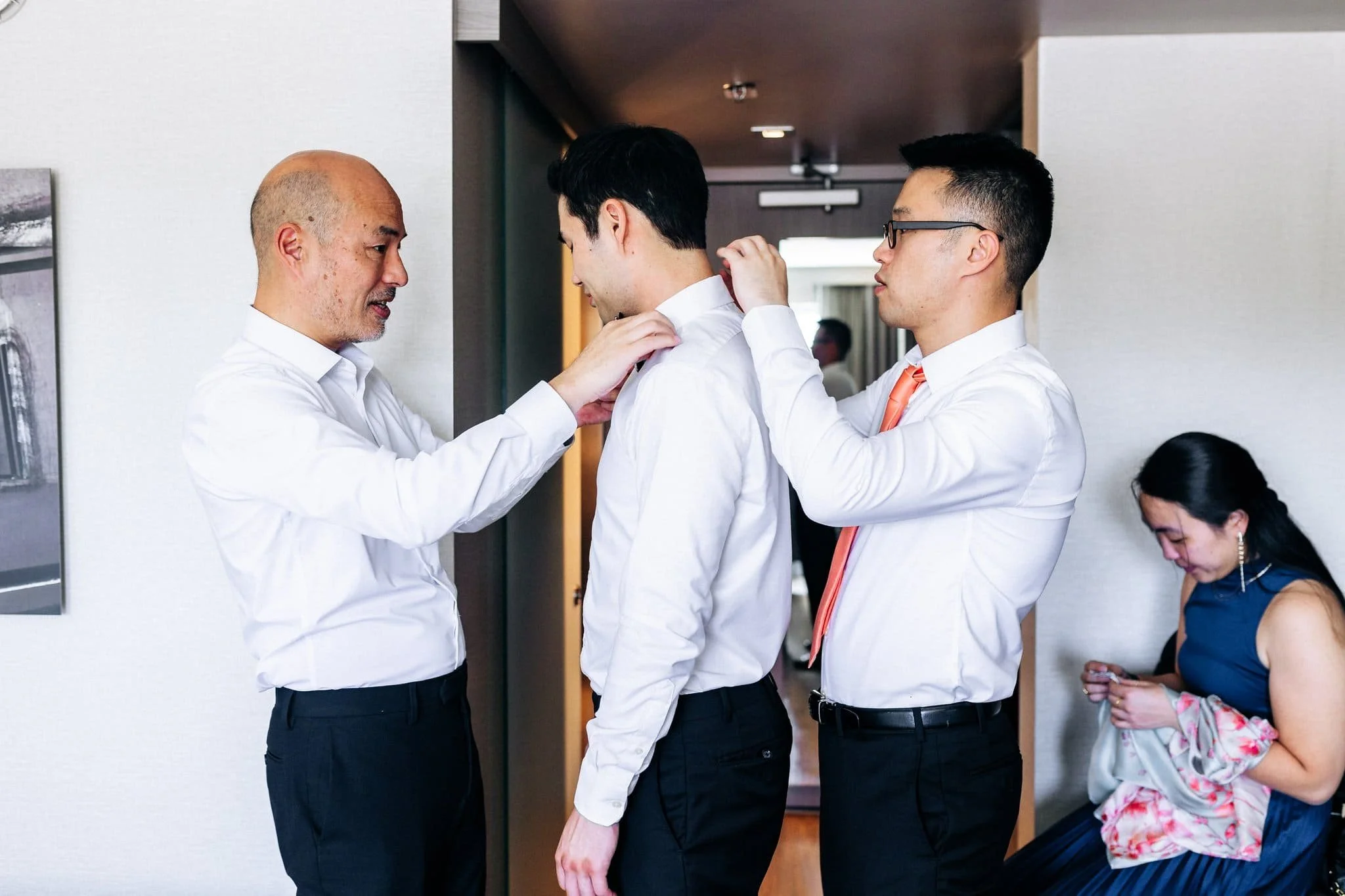 groomsmen helping groom get dressed getting ready palm event center pleasanton wedding