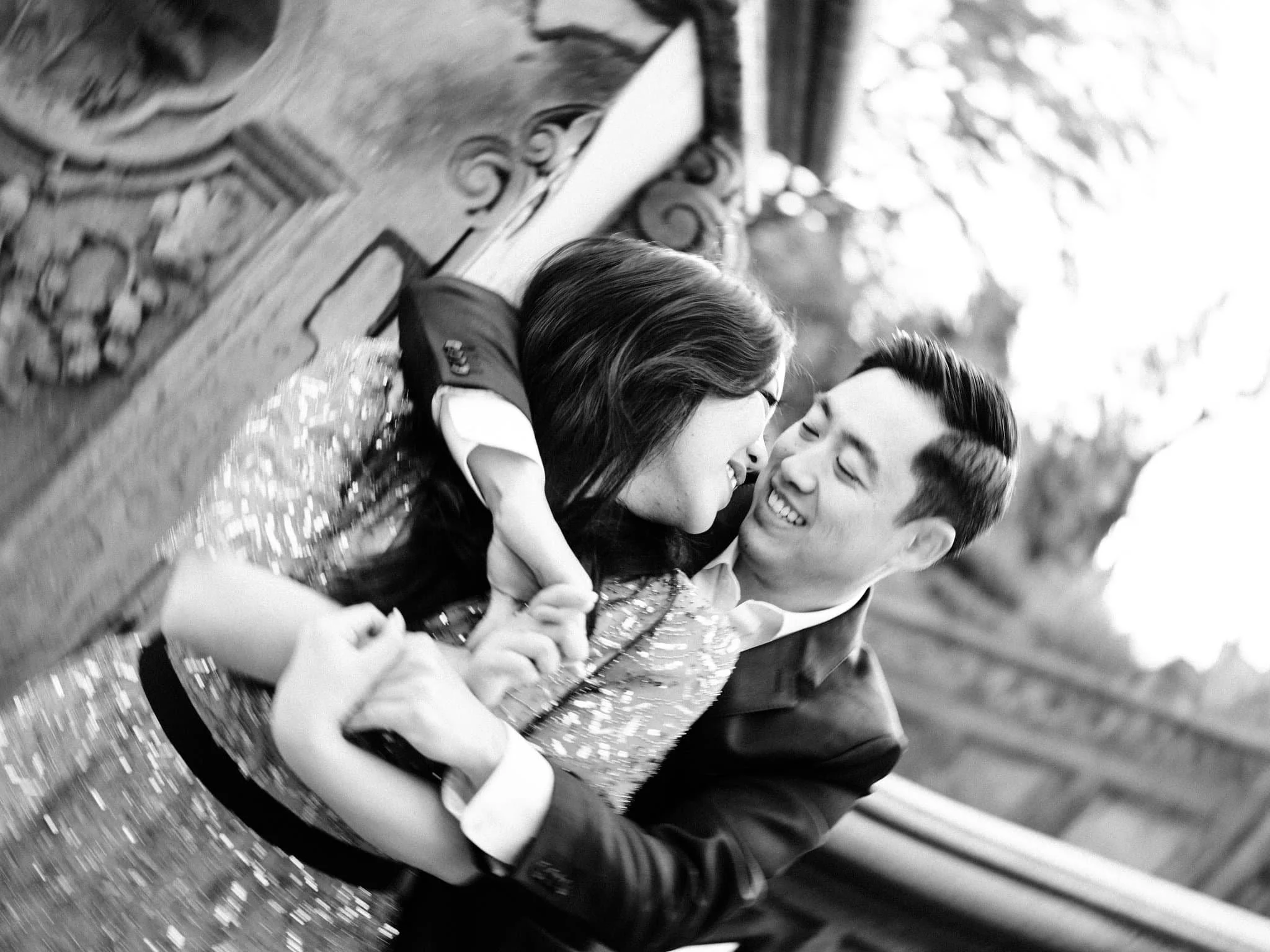Engaged couple embracing from behind during their Central Park engagement photo session in New York City.