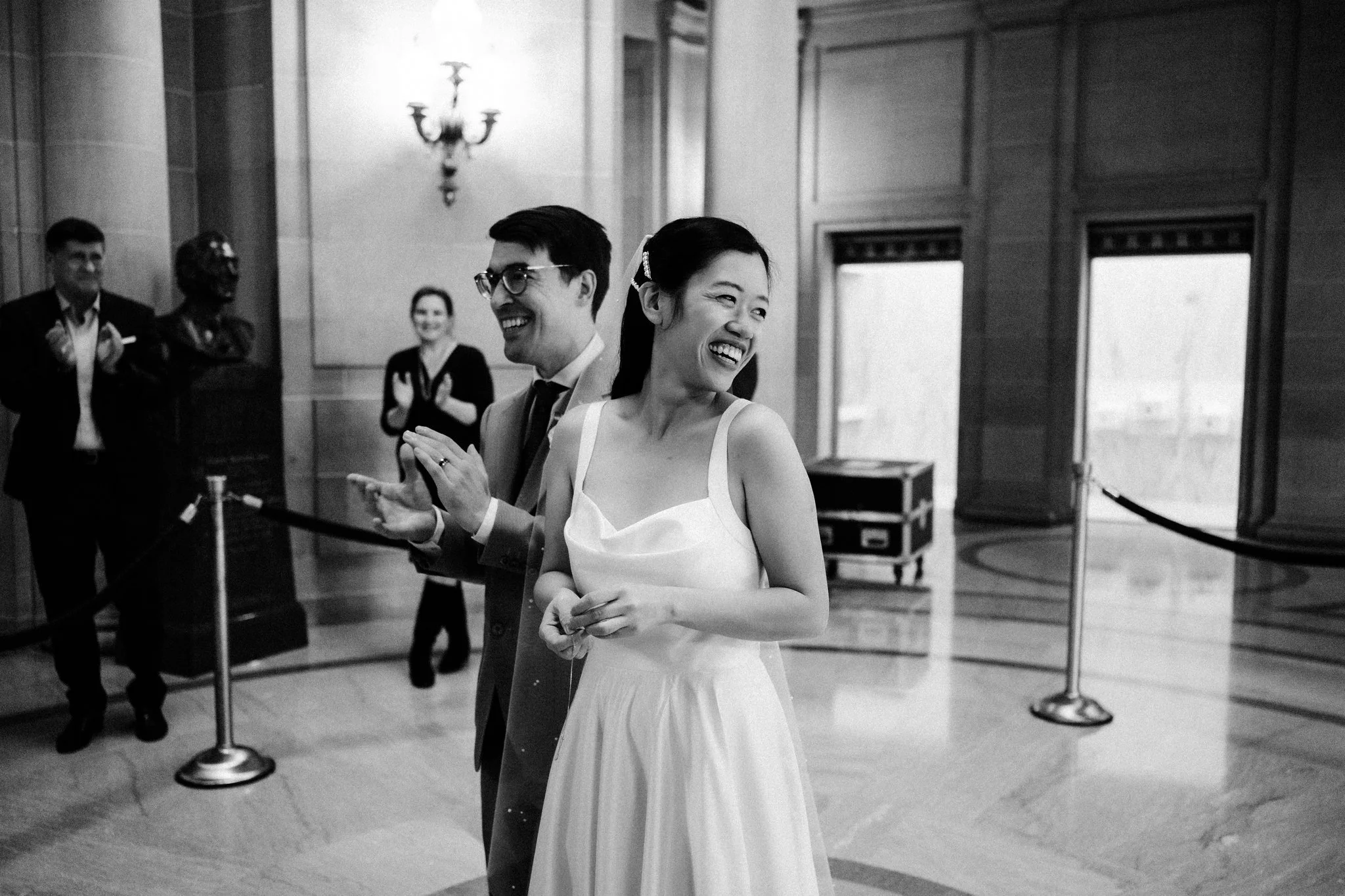 Bride and groom walking away after ceremony at San Francisco City Hall wedding