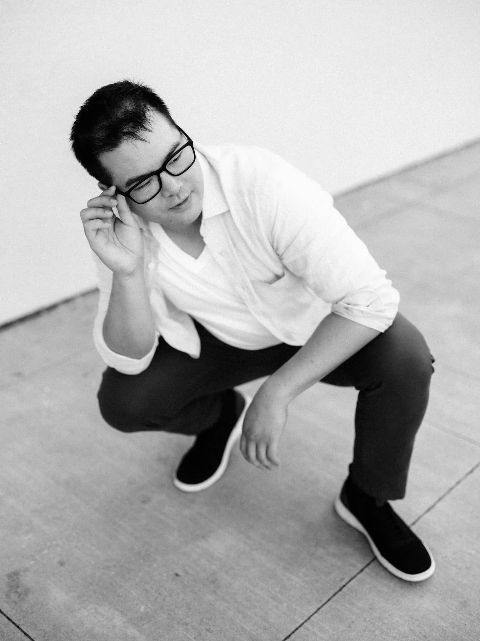 Groom-to-be crouching down for a portrait during his engagement session at Montalvo Arts Center in Saratoga.