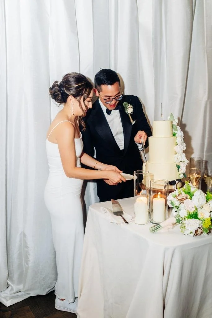 Bride and groom cutting their wedding cake together