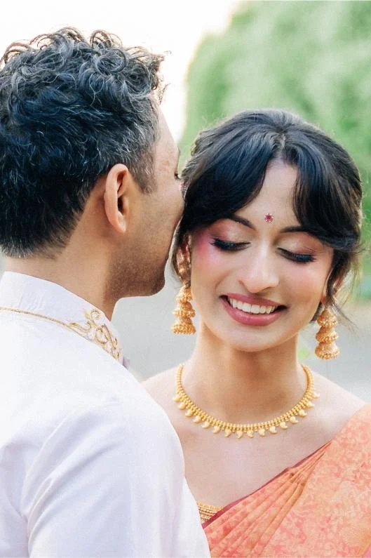 Groom whispering in the bride’s ear during portraits before the wedding ceremony