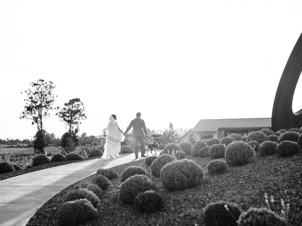 Bride and groom walking together along a path at Stanly Ranch