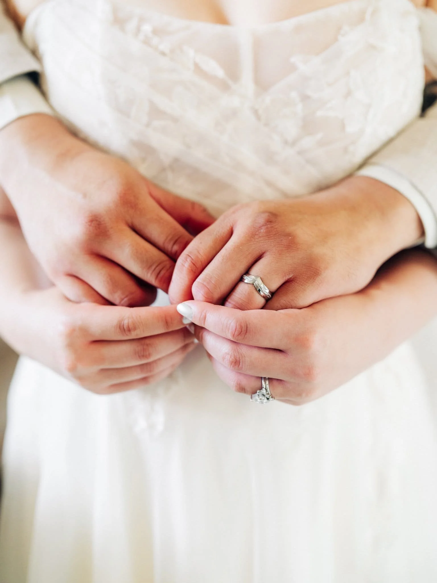 Close-up of the bride and groom embracing with their wedding rings visible during their San Francisco City Hall elopement.