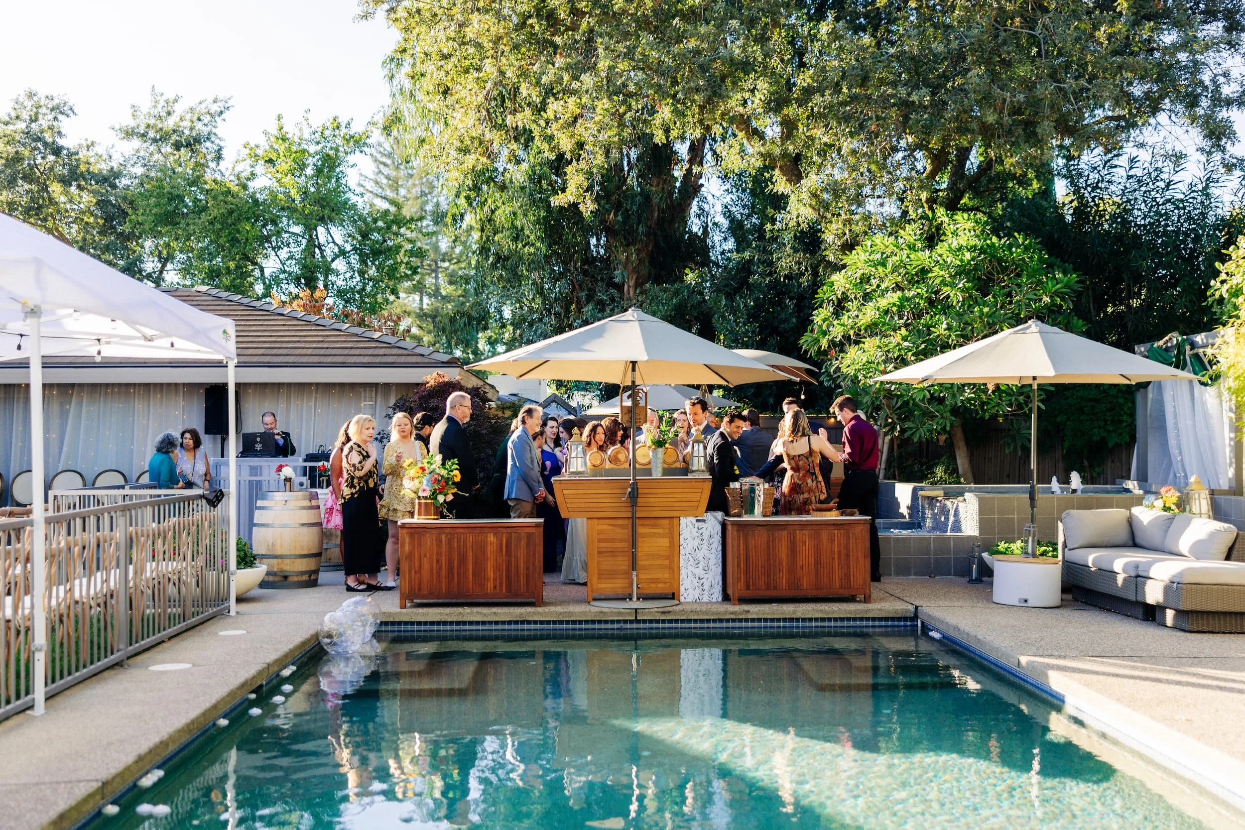 Guests enjoying cocktail hour by the pool during Sacramento wedding reception