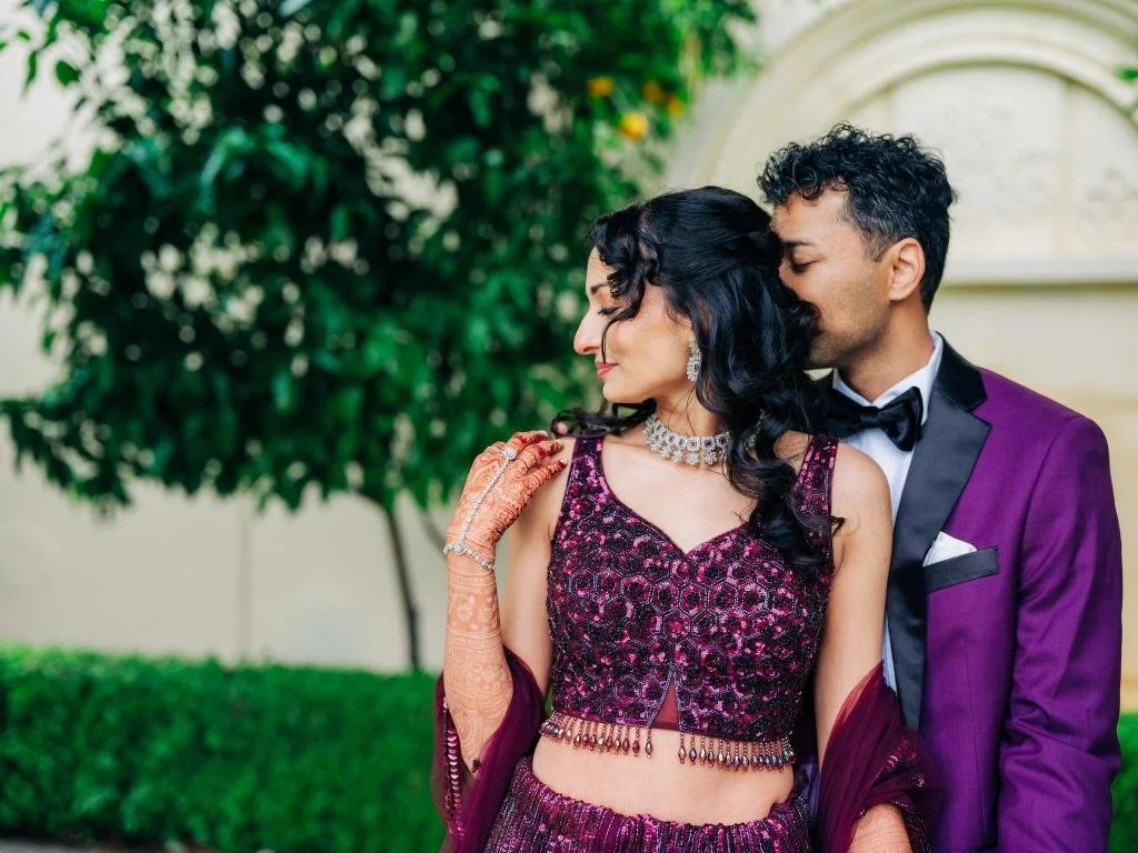Groom embracing the bride from behind during wedding portraits