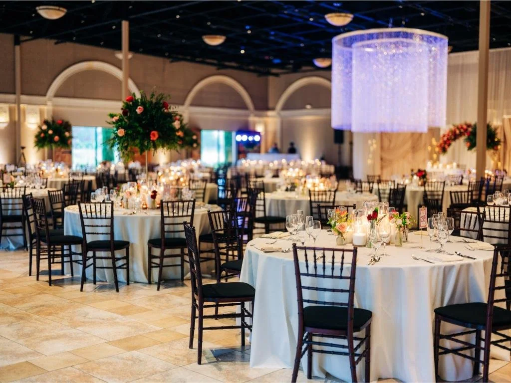 Reception dining tables and seating arranged for Nishi and Rohan’s wedding guests