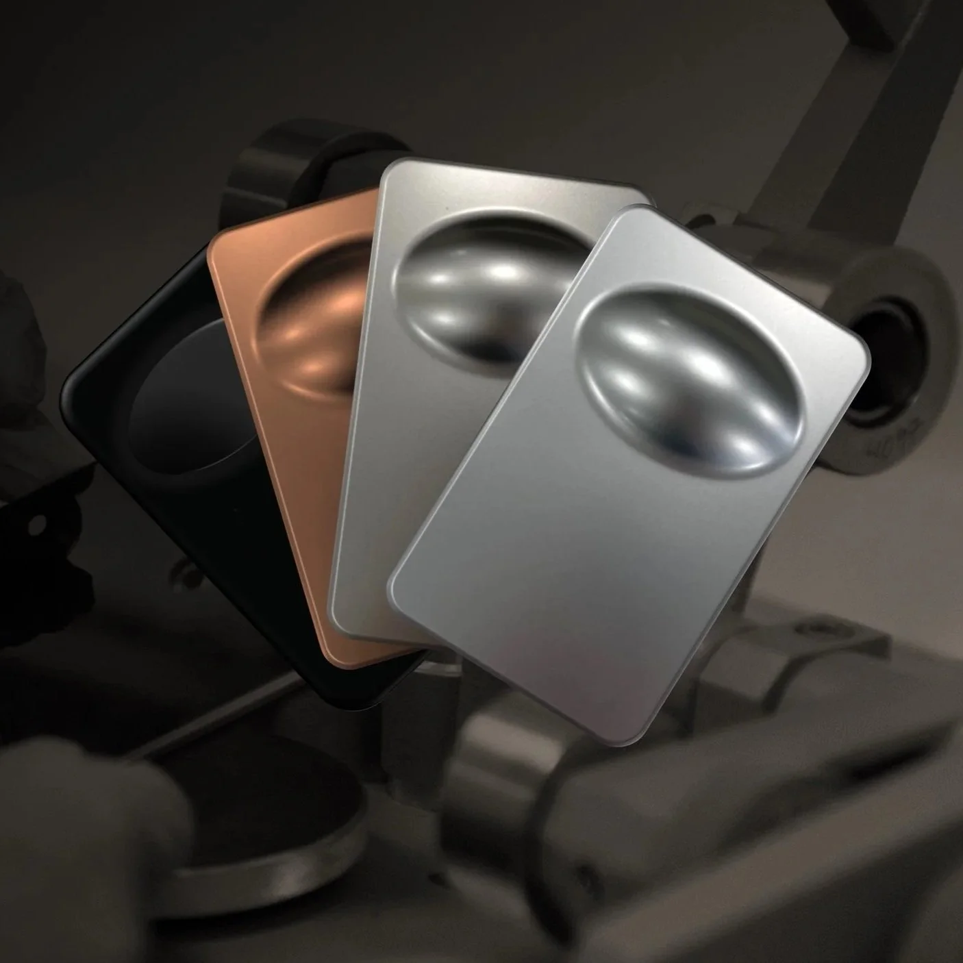 Three metallic powering banks arranged in a row, with a black, copper, and silver color, placed on an exercise machine.