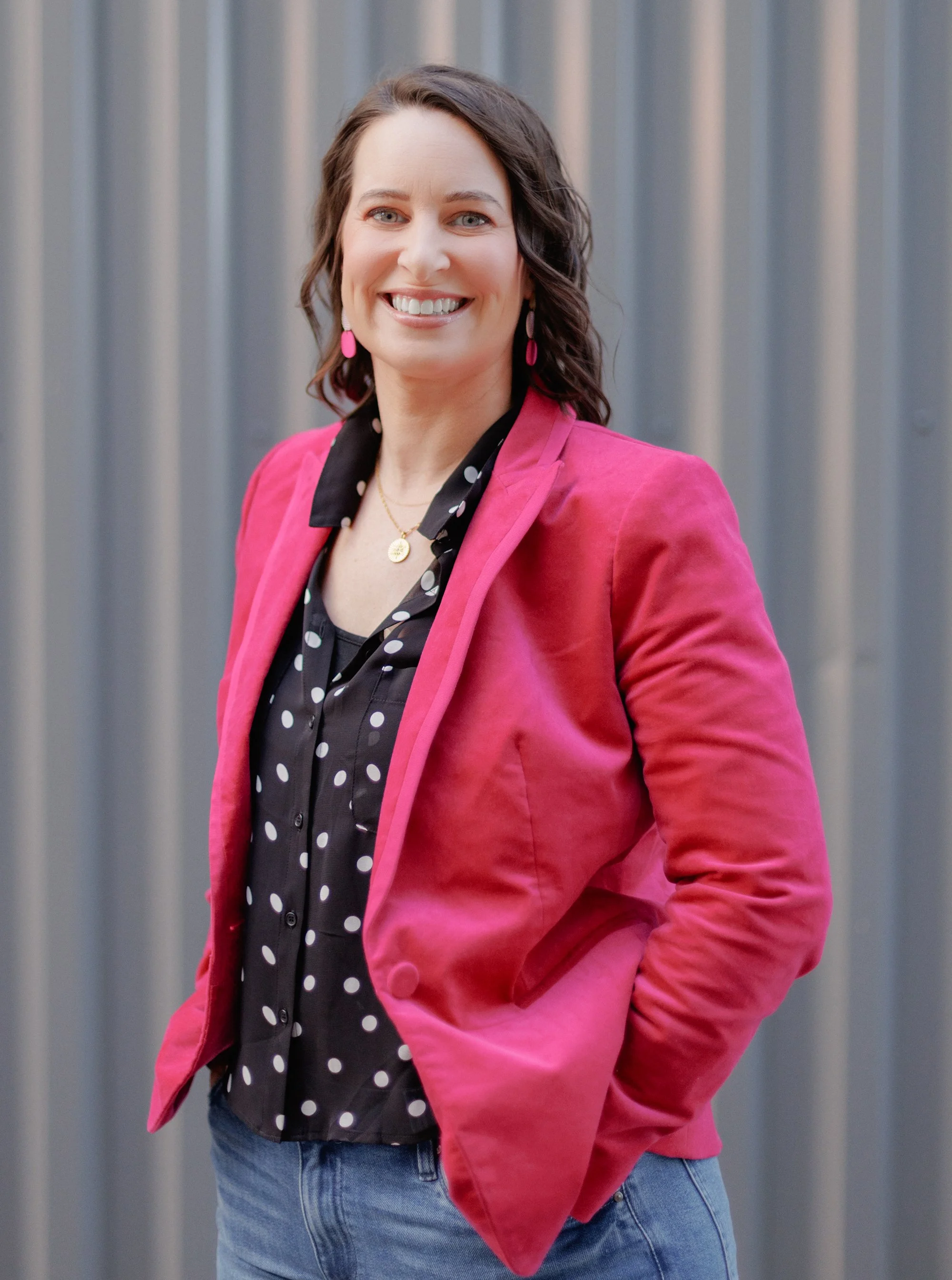 Founder, Suzanne Patel, dressed in a pink blazer.