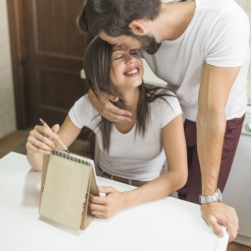 young-man-embracing-writing-girlfriend.jpg