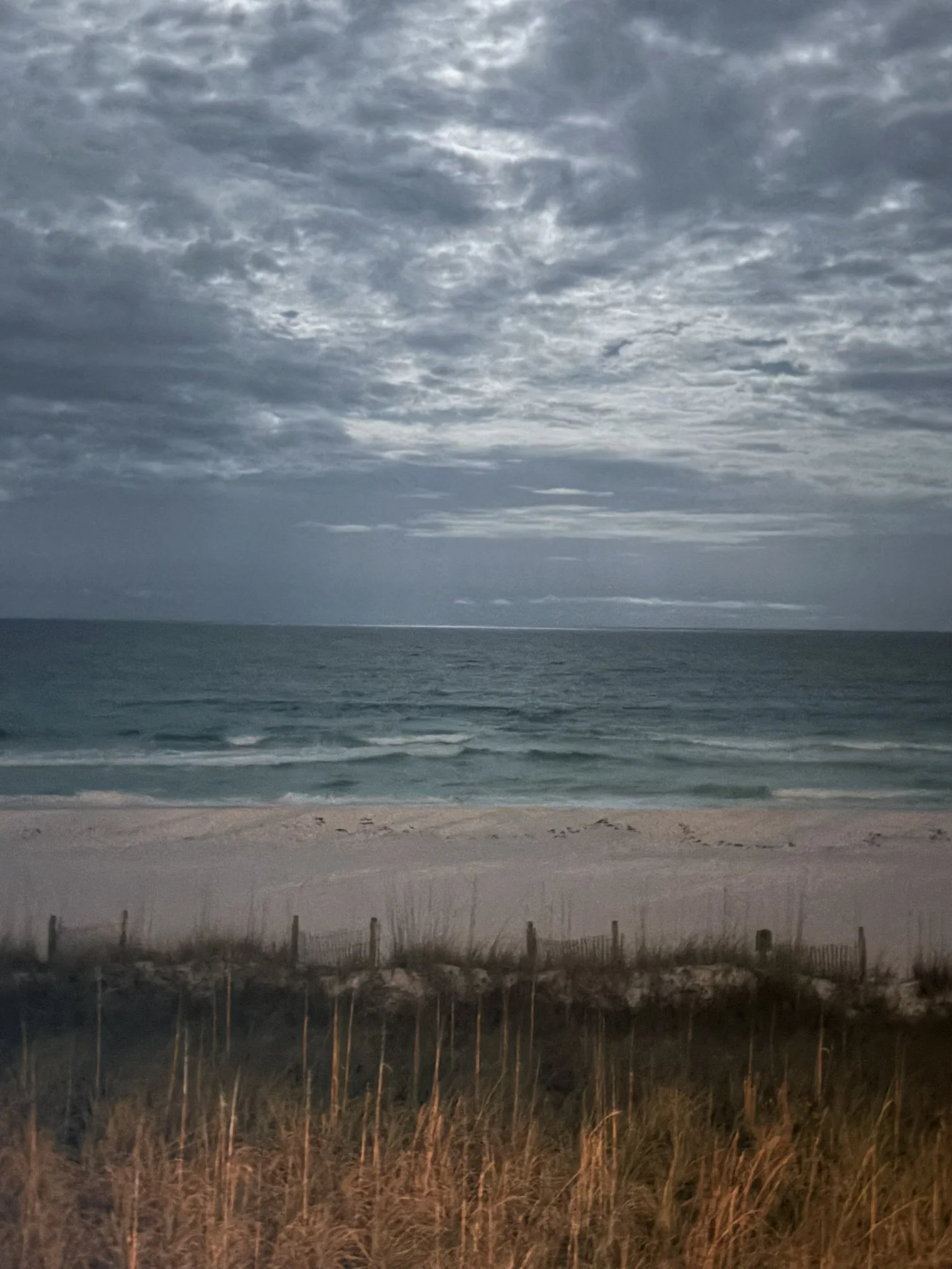 Storm clouds over the ocean representing the emotional journey of healing from childhood trauma.