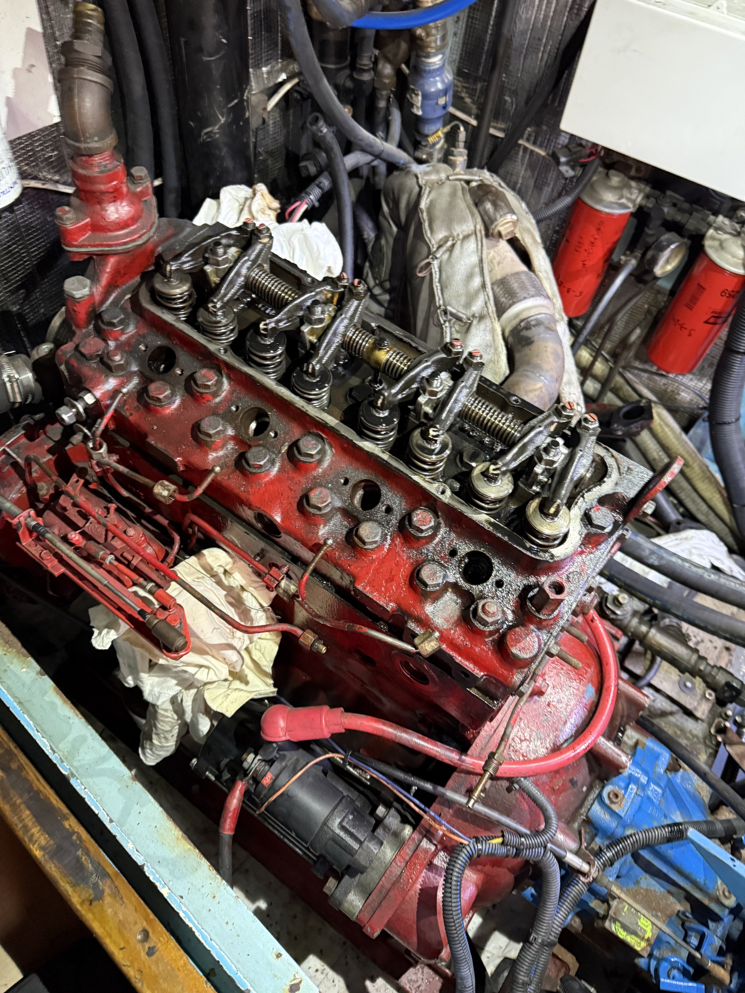 After draining coolant, removing the intake manifold, injectors, fuel filter assembly, and valve cover. This is about the halfway point before removing the cylinder head to change the head gasket. Exhaust manifold, fuel lines, rocker assembly, and pu