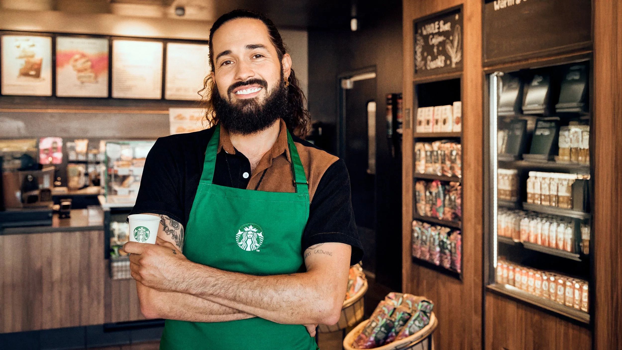 Starbucks barista posing confidently in-store for a commercial photo and video project created by LA photographer and cinematographer Sam Grant.