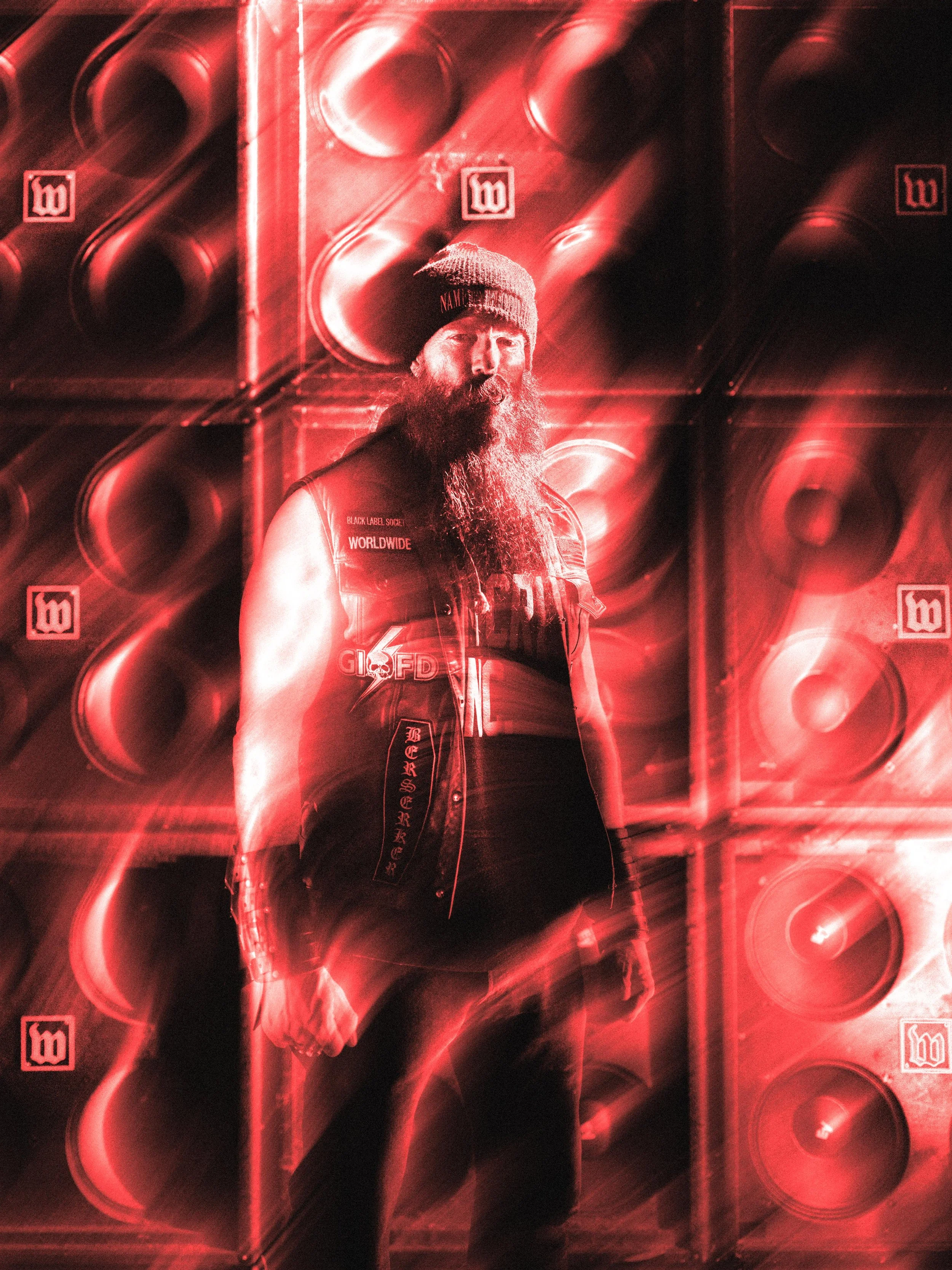 Zakk Wylde standing in front of his signature Wylde Audio amp wall during the 50W Mini Amp launch shoot.