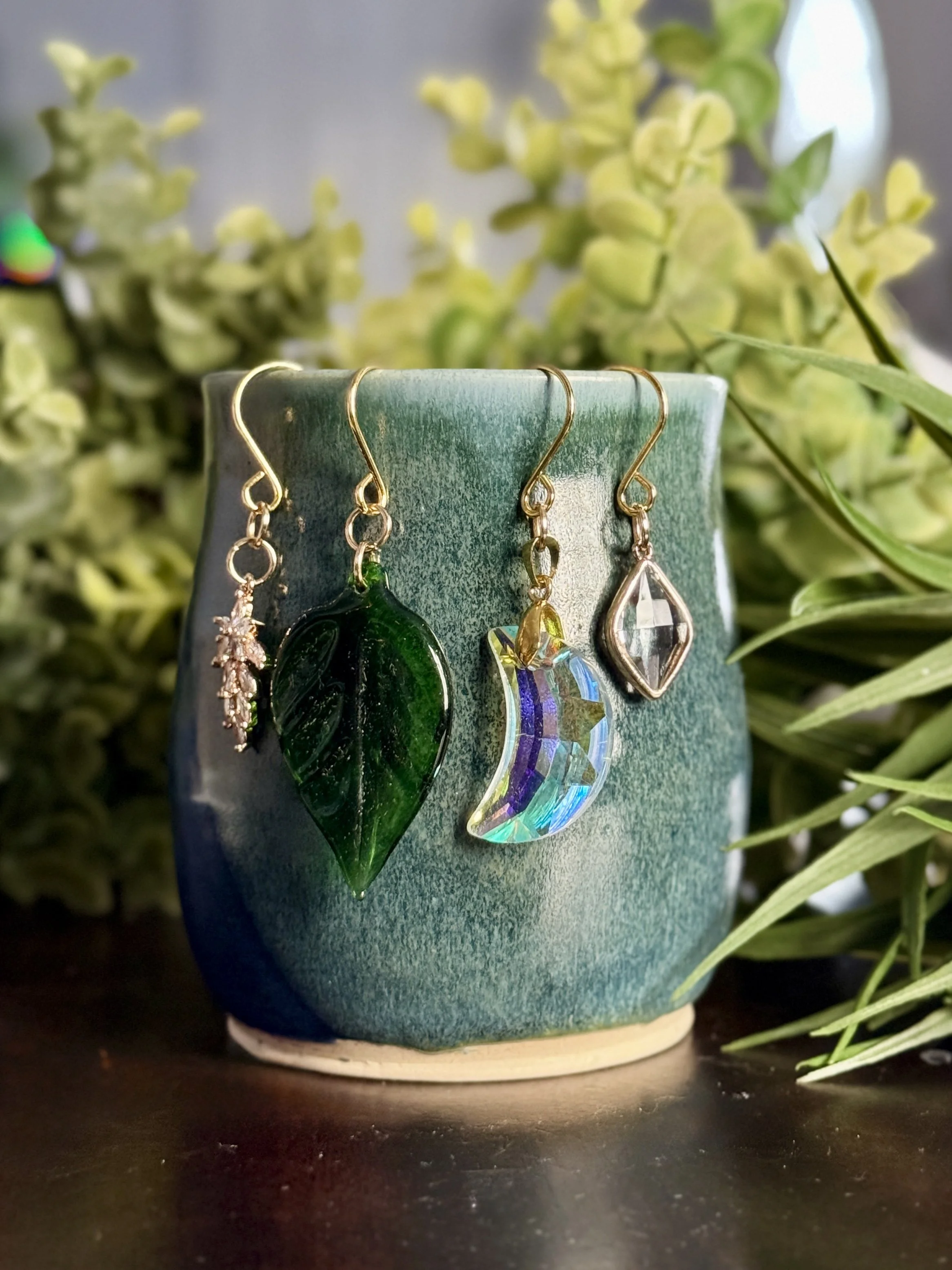 2nd Front View of Crystal moon + antique glass leaf + 2 crystal pendant plant charms of a mug with leafy background