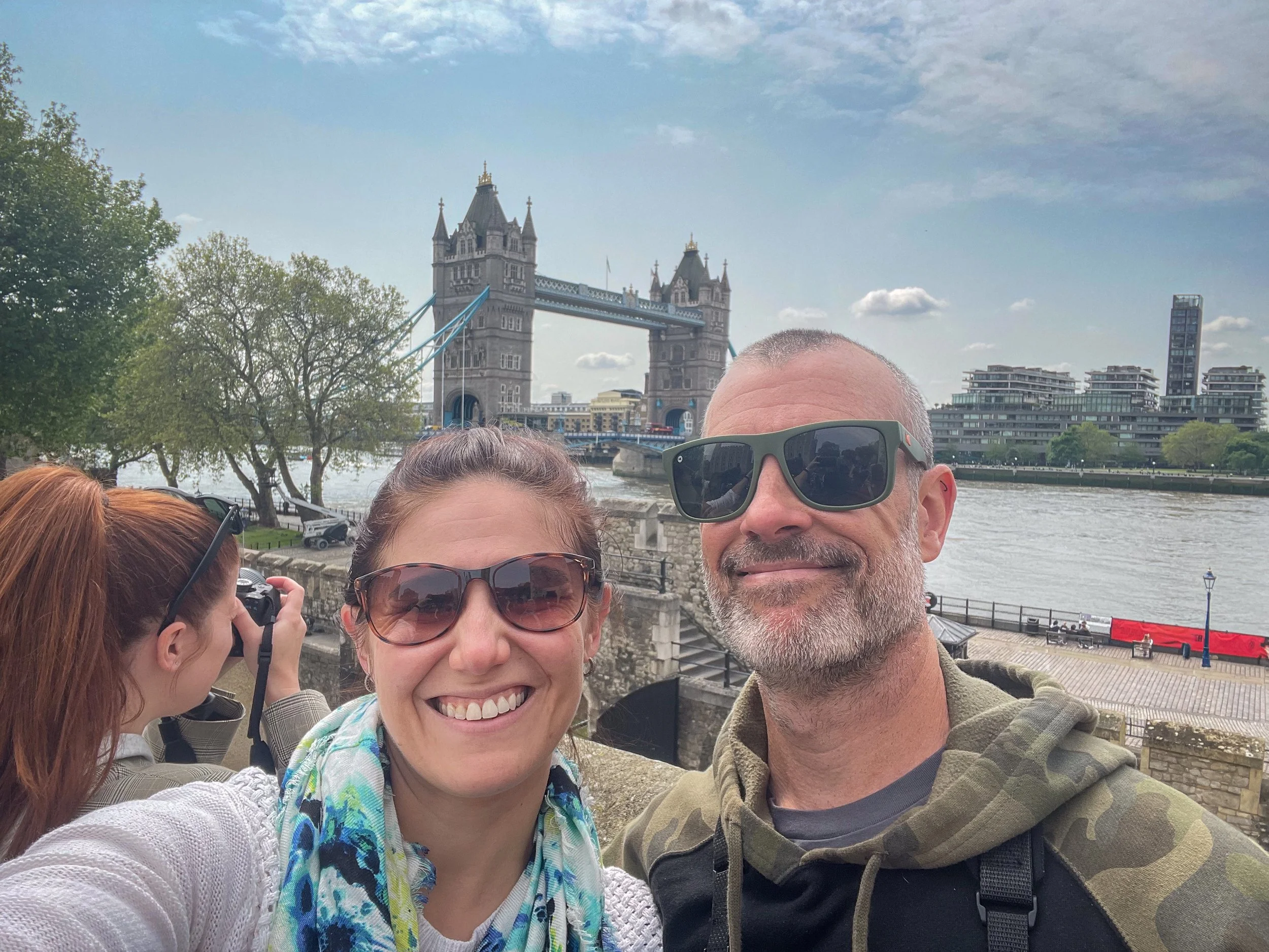 Michelle and Chris Coverdill taking a selfie with Tower Bridge in London.
