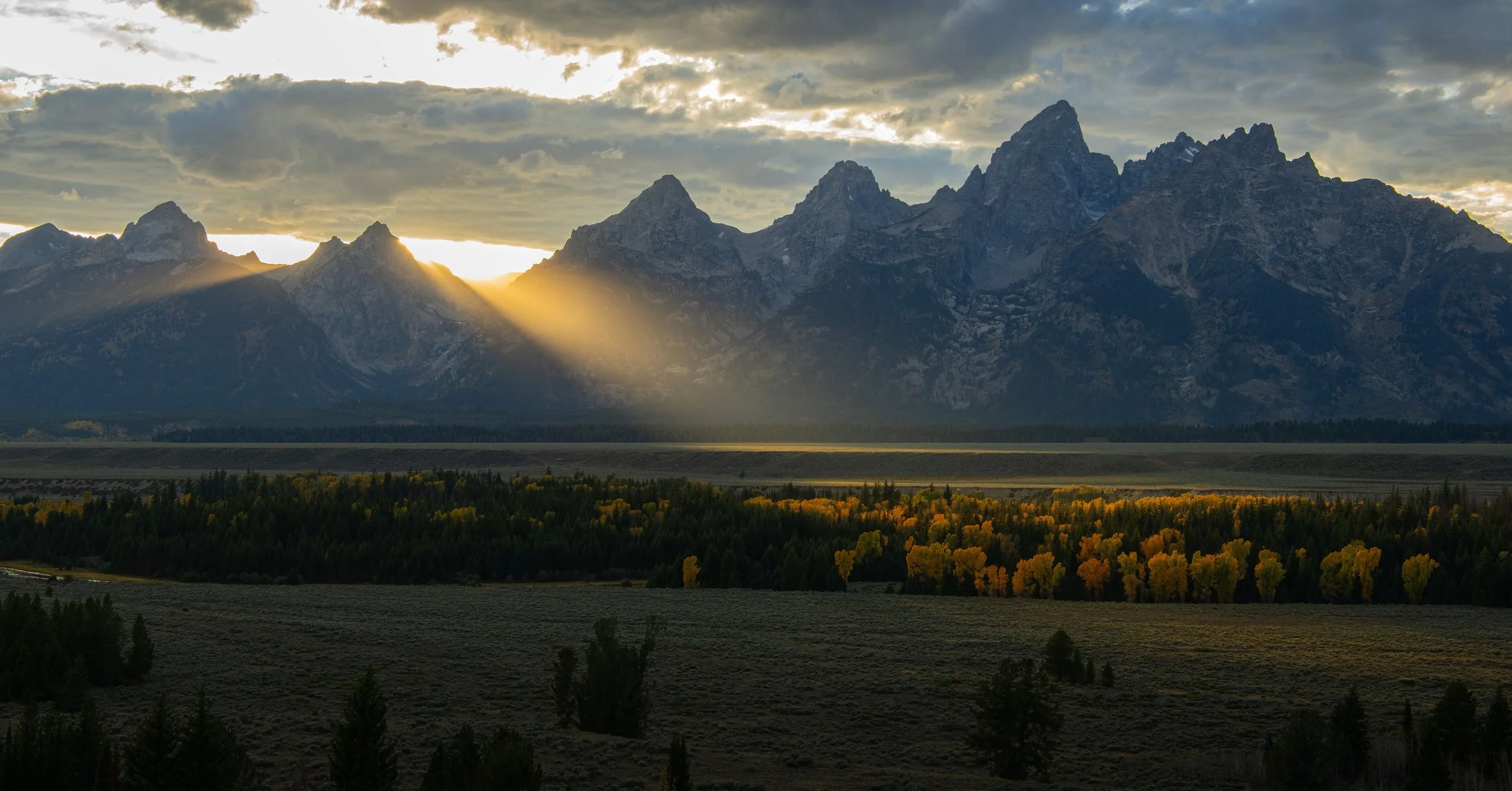 Sun behind the mountains in the Grand Tetons .jpg