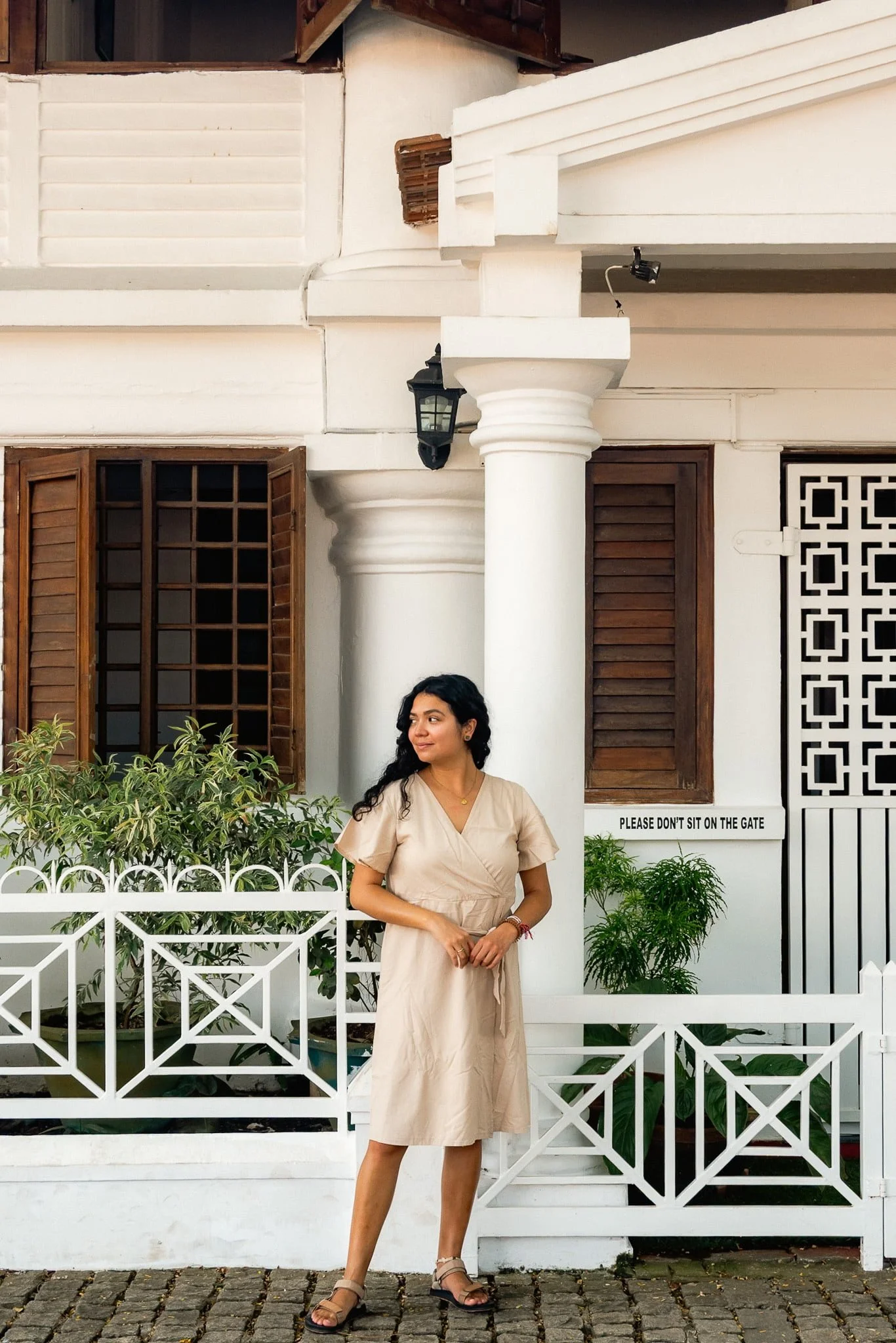 Ingrid from The Real Traveler in front of a colonial building in Fort Kochi.