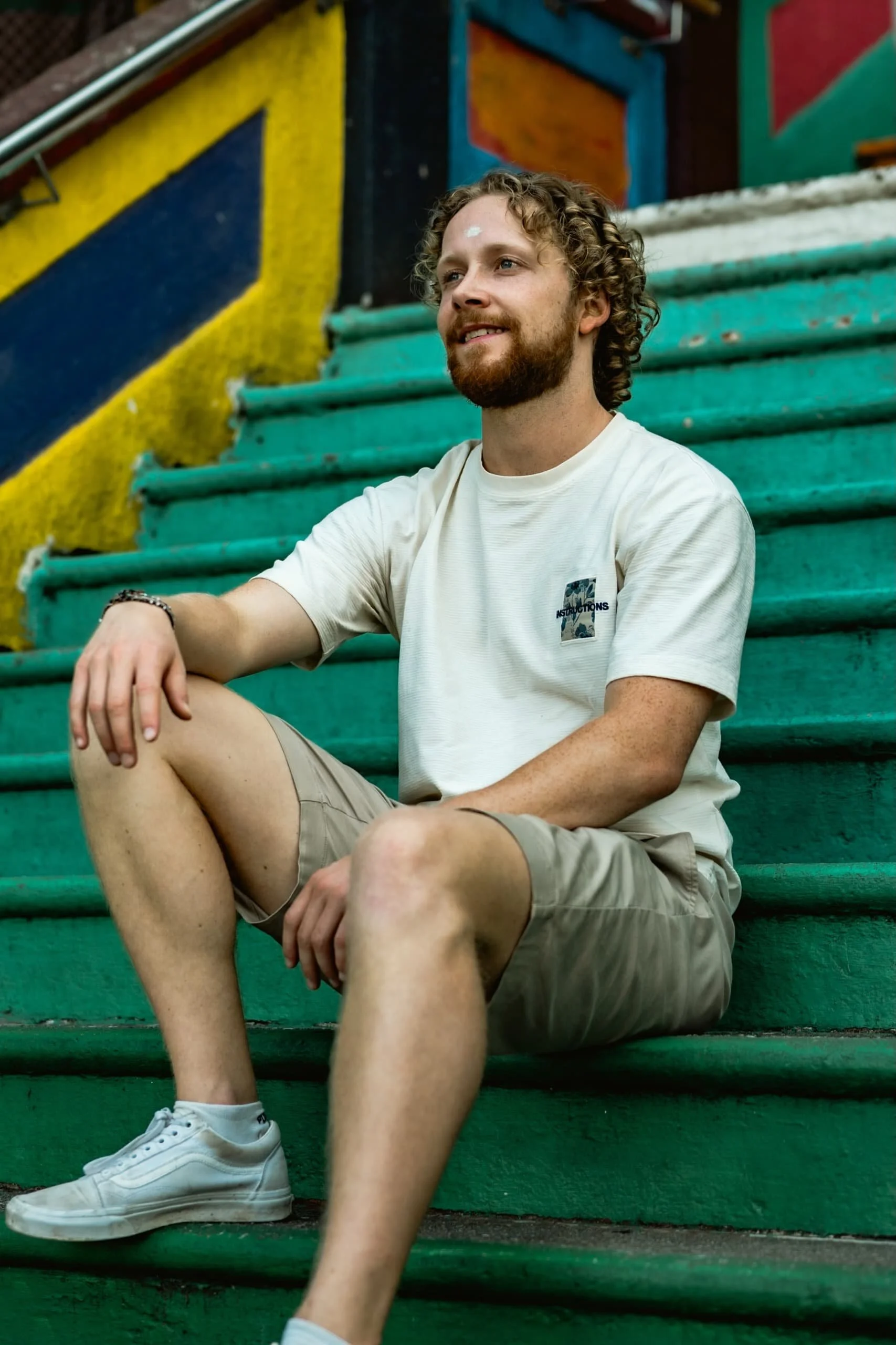 A traveler posing on the famous rainbow stairs in KL