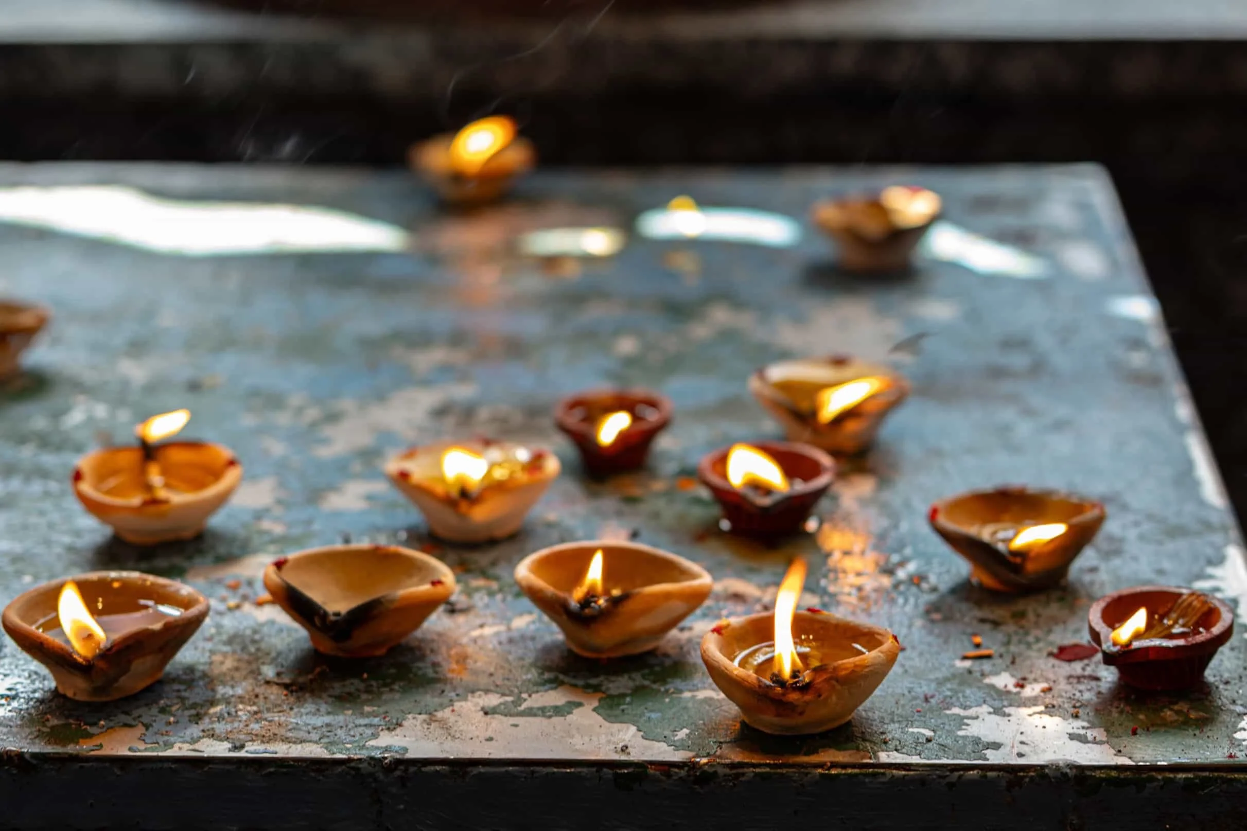 Offerings of couple of well lit diyas/lamps in Batu Caves temple in Malaysia.