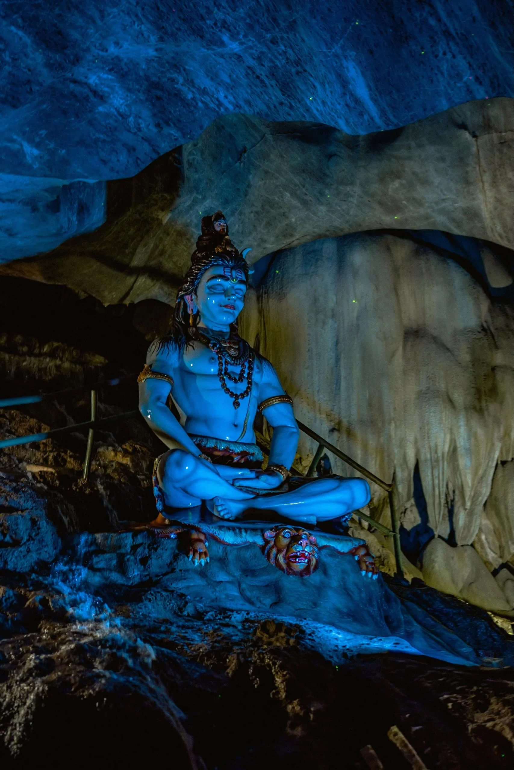 A beautiful statue of lord Shiva sitting in meditation posture inside Ramayana Cave at Batu Caves temple.