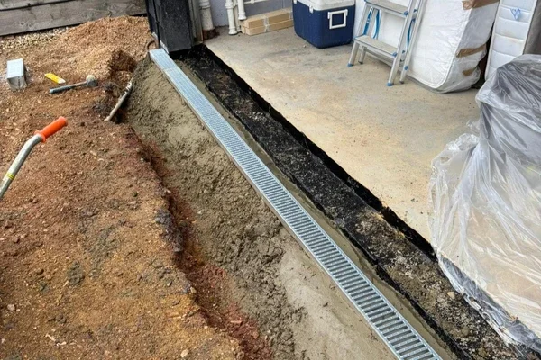 Flowcraft installing an ACO drainage system to fix basement flooding in Hitchin