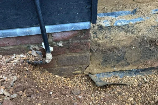 Flowcraft investigating the ground immediately along the front of a garage, identifying water ingress.