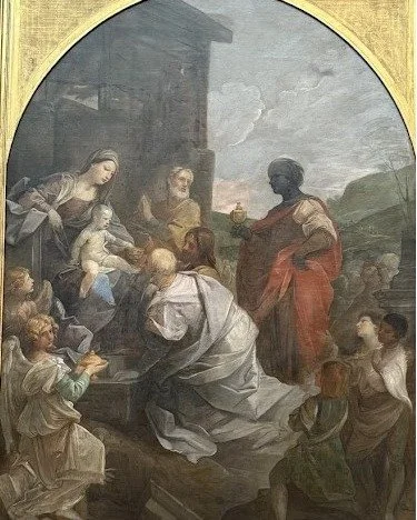 Adoration of the Magi (1642) Guido Reni.  The museum places this large altarpiece on the opposite wall from Caravaggio's Crucifixion of St. Andrew.  The Reni wall represents his version of idealism, where he draws from nature but enhances it to attem