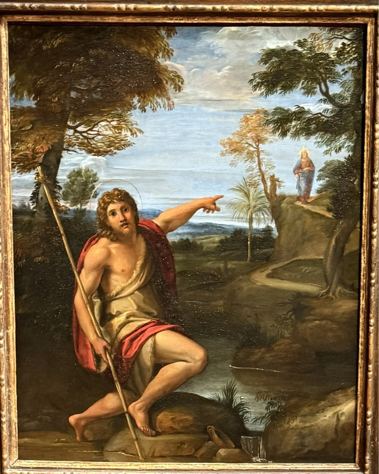 Saint John the Baptist Bearing Witness (c.1600) Annibale Caracci.  Here we see John the Baptist wearing his usual animal skin clothing and carrying a staff with the cross on top.  The saint has turned toward us to direct our attention to a figure in 