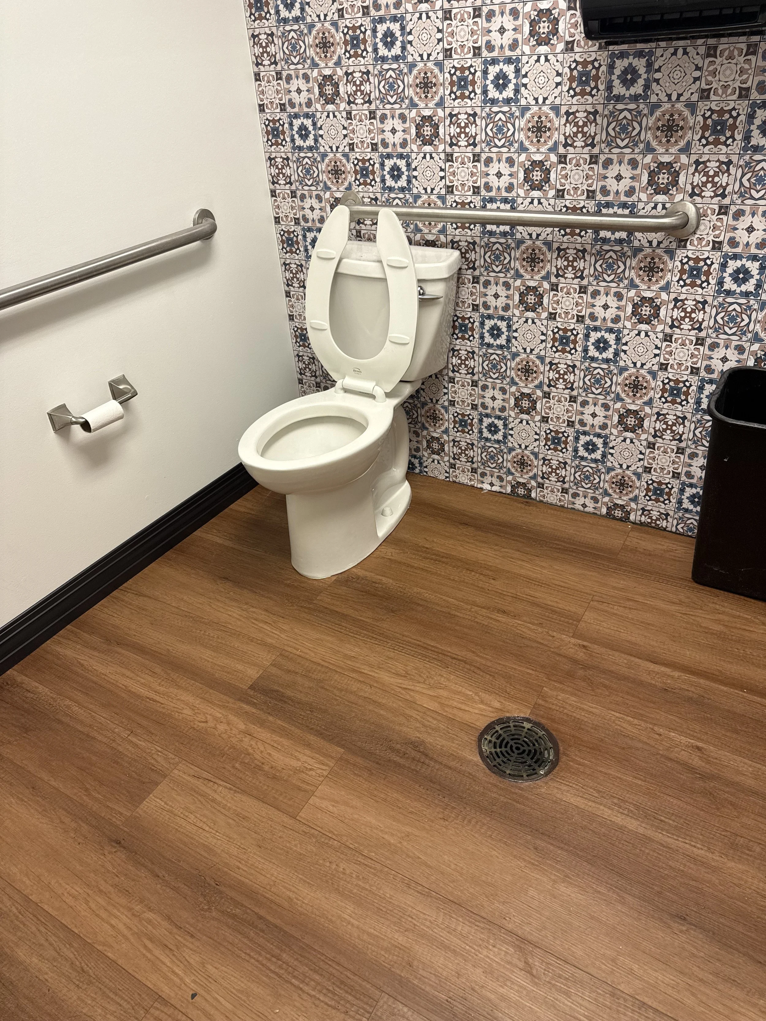 bathroom wallpaper and wood flooring.jpeg