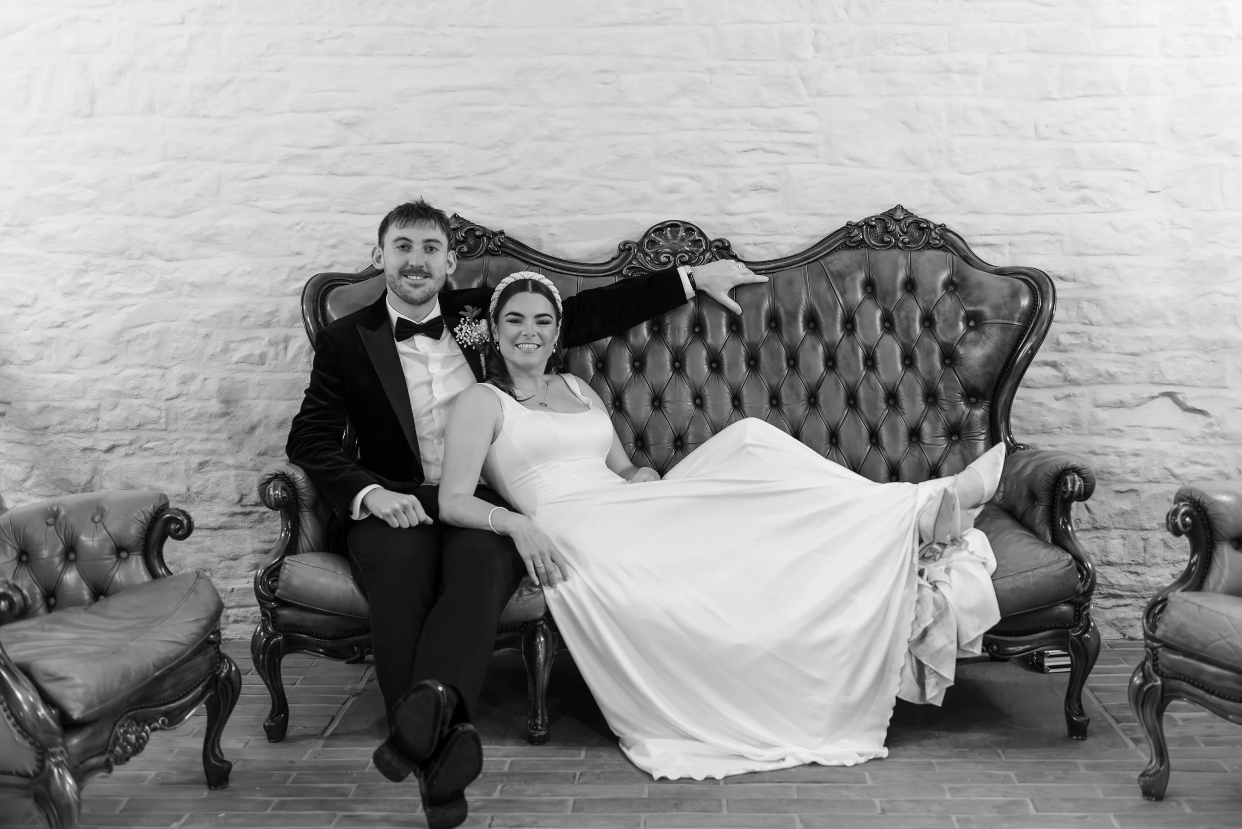 Black and White editorial style posed shot of a couple in wedding attire at llantilio house, abergavenny, monmouthshire