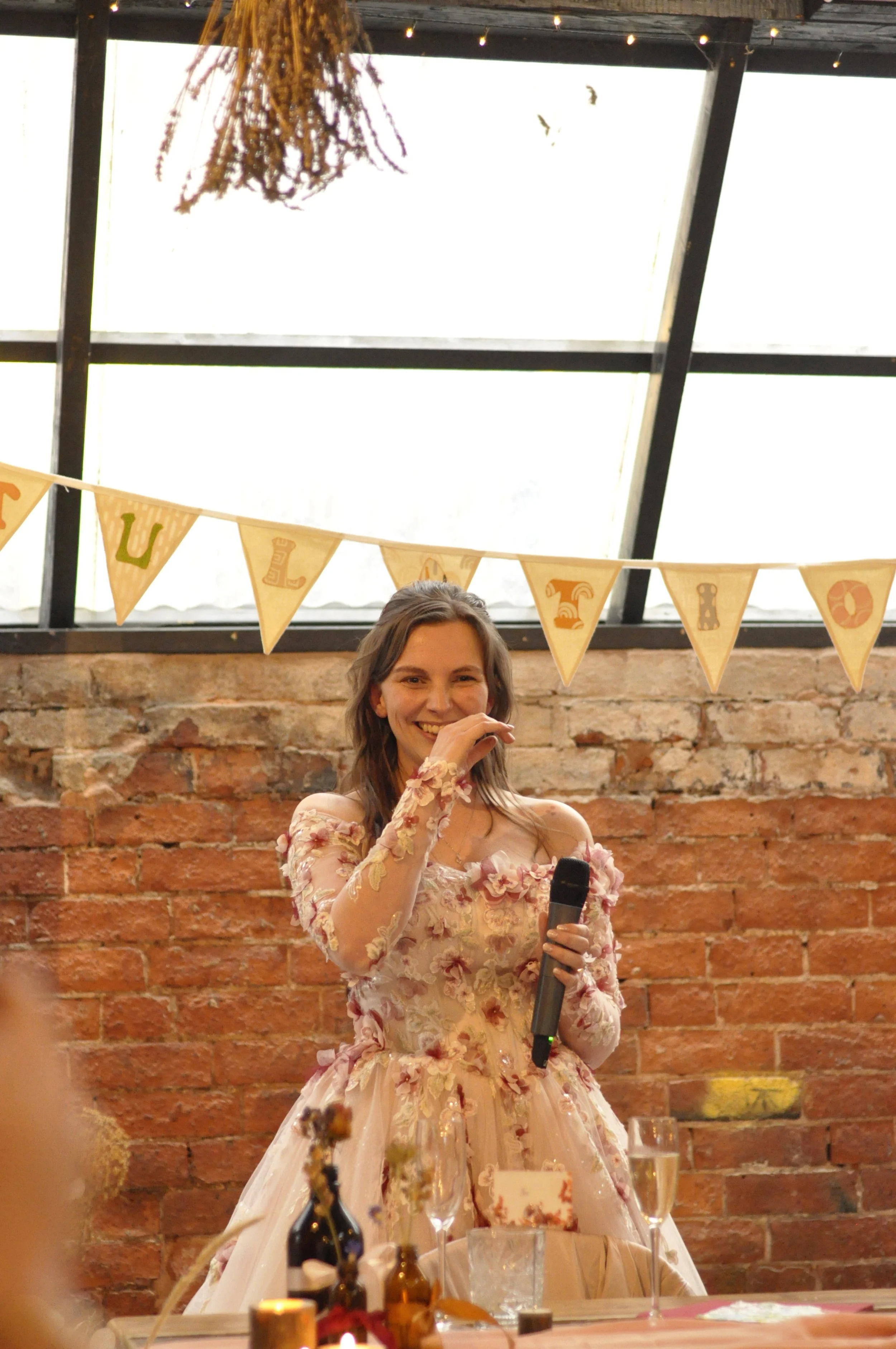 colourful wedding dress bride, pink dress with flowers, warehouse venue, exposed brick