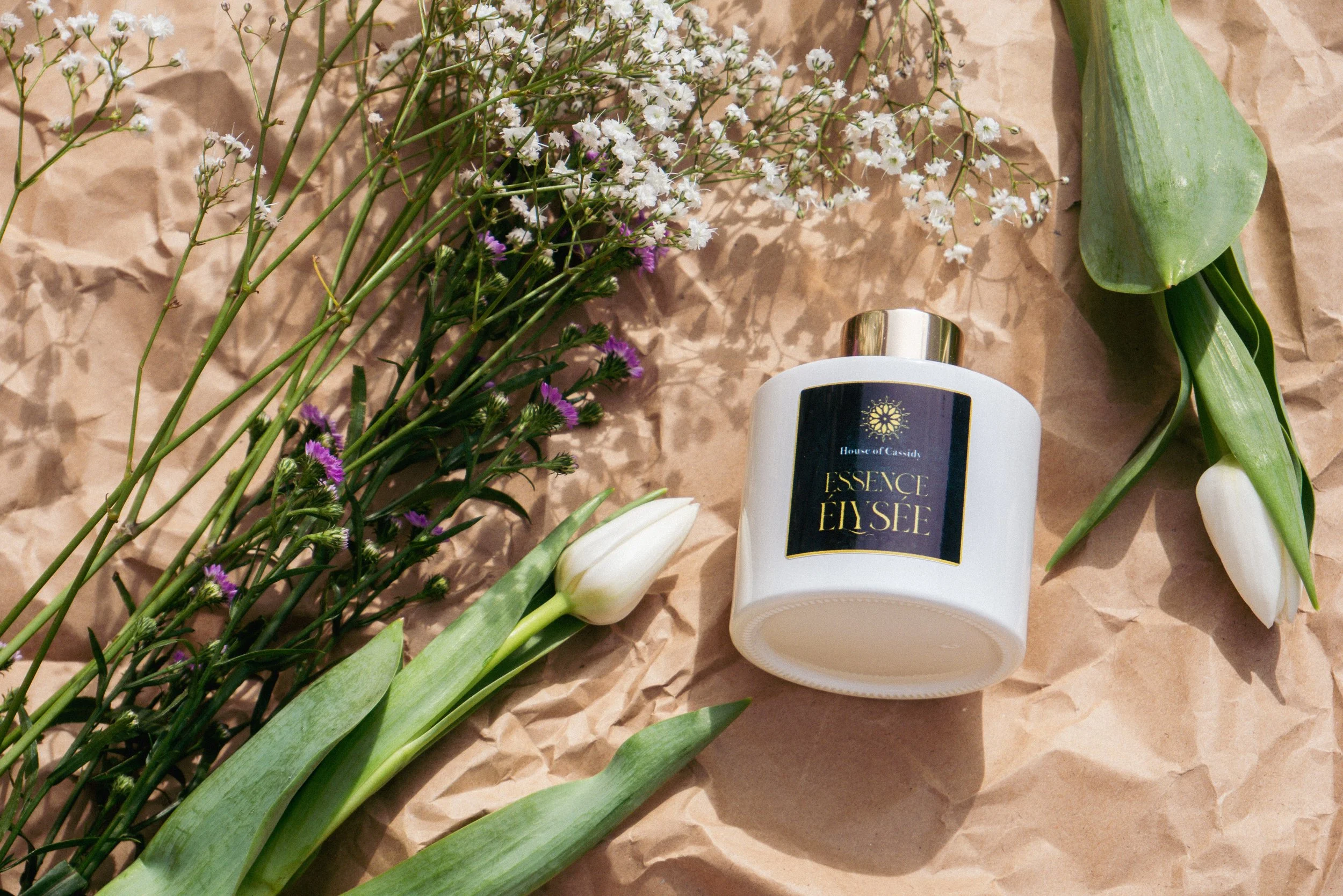 Essence Elyse Reed Diffuser surrounded by flowers 