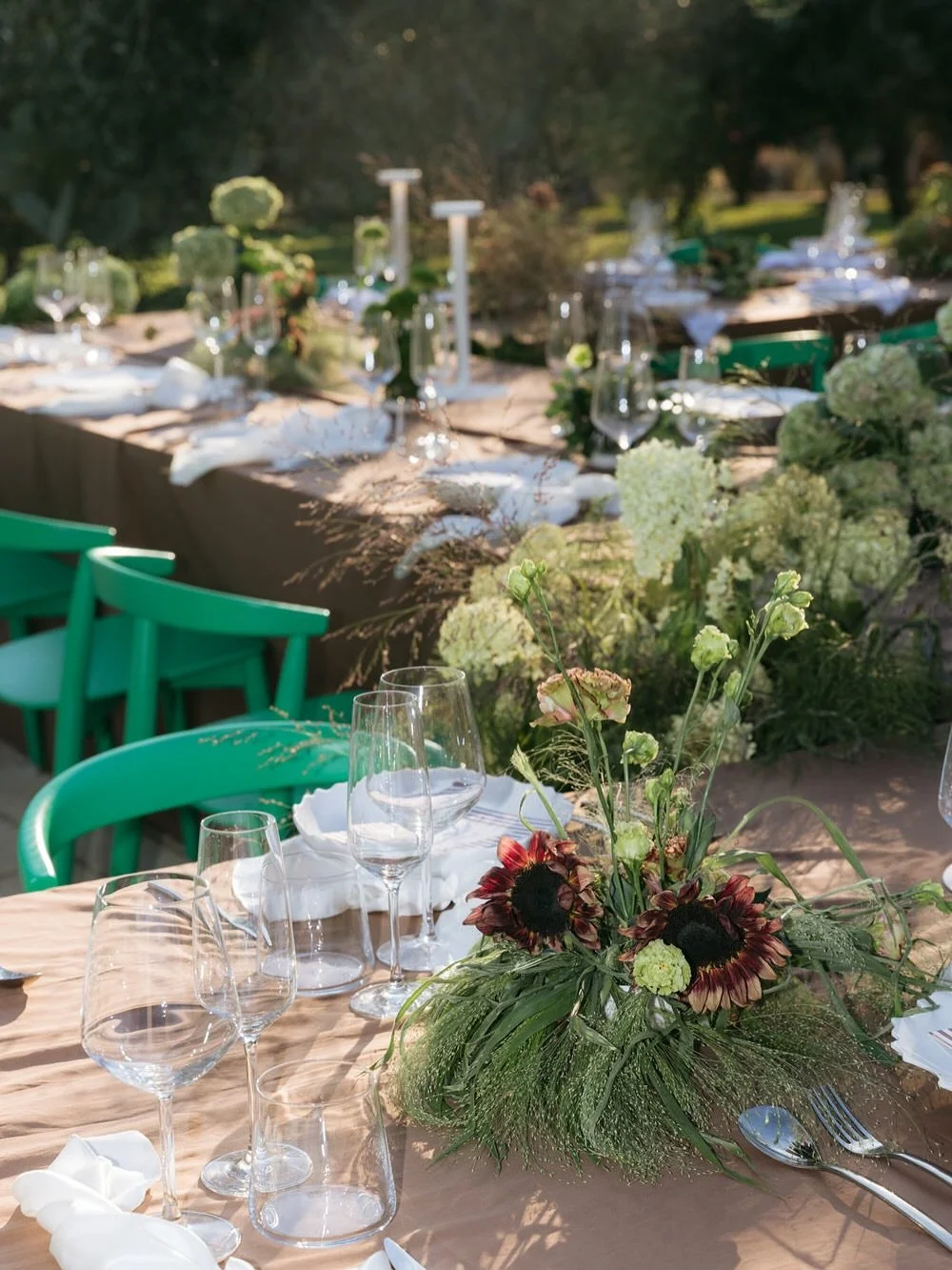 at this braccialieri wedding, the design wasn&rsquo;t about extravagance. 
it was about harmony. 
earth-toned linens, wild blooms, green chairs tucked between olive trees. 
a table not just styled, but placed with reverence for the landscape. 

this 