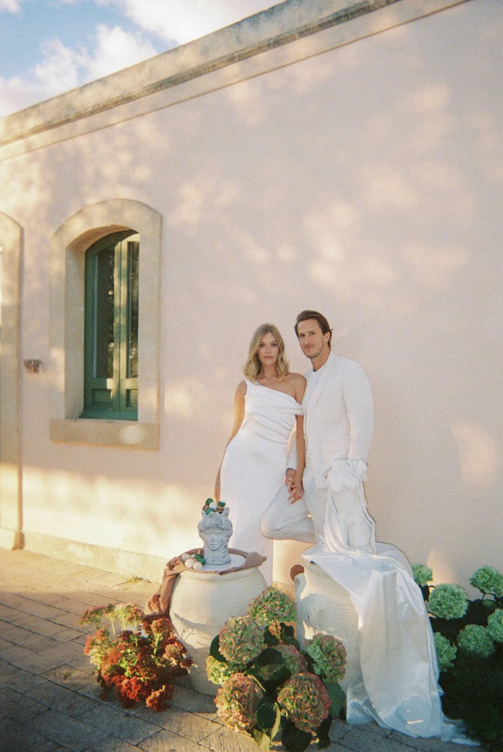 Romantic couple portrait on 35mm film at a chic braccialieri sicily destination wedding with soft and gold mediterranean light