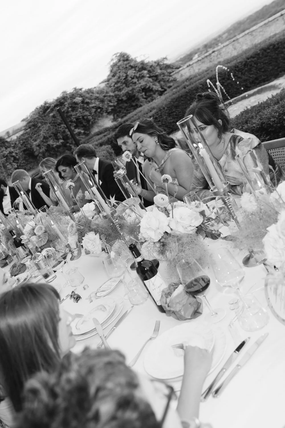 Candid Guests moment seated at an outdoor dinner table during a Palagina Tuscany wedding celebration