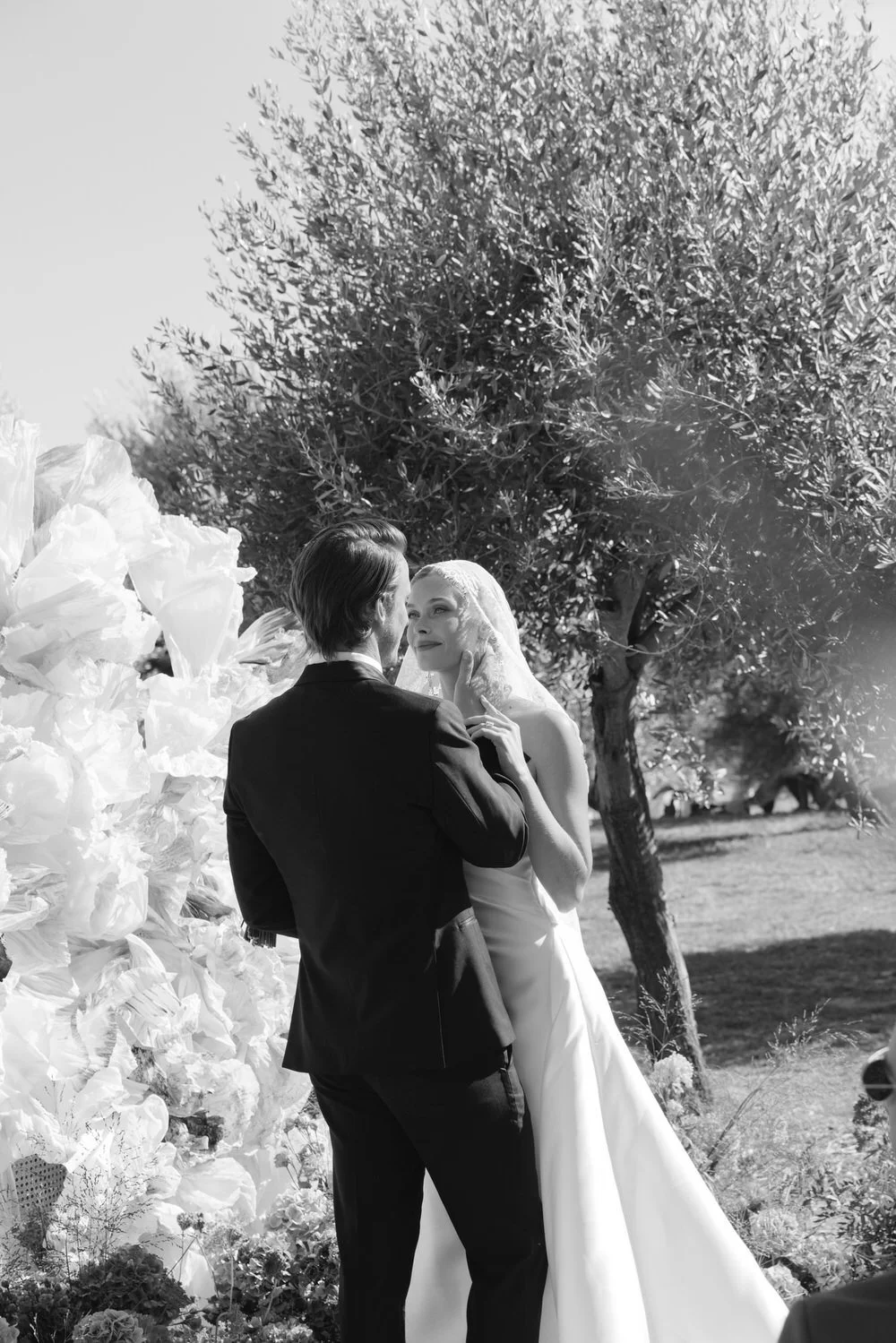 During a sunlit wedding ceremony beneath olive trees, emotion unfolds with quiet elegance, capturing the soulful atmosphere of a Braccialieri Sicily wedding in a timeless, editorial way
