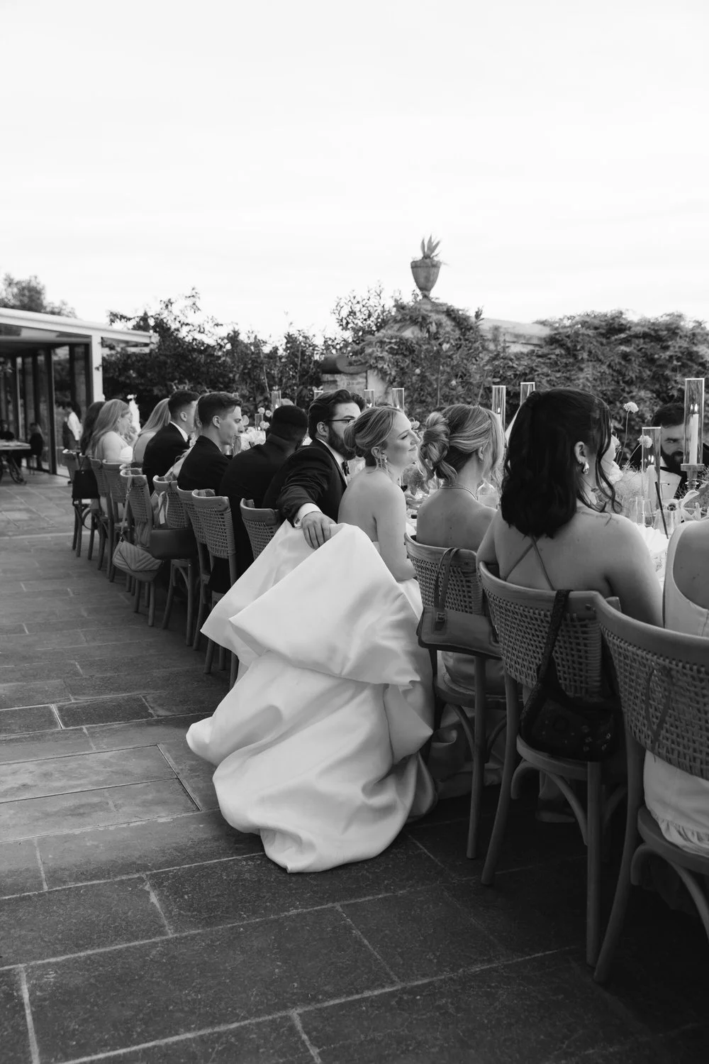 Back view of the bride and groom sharing a moment at the reception table during a Palagina Tuscany wedding