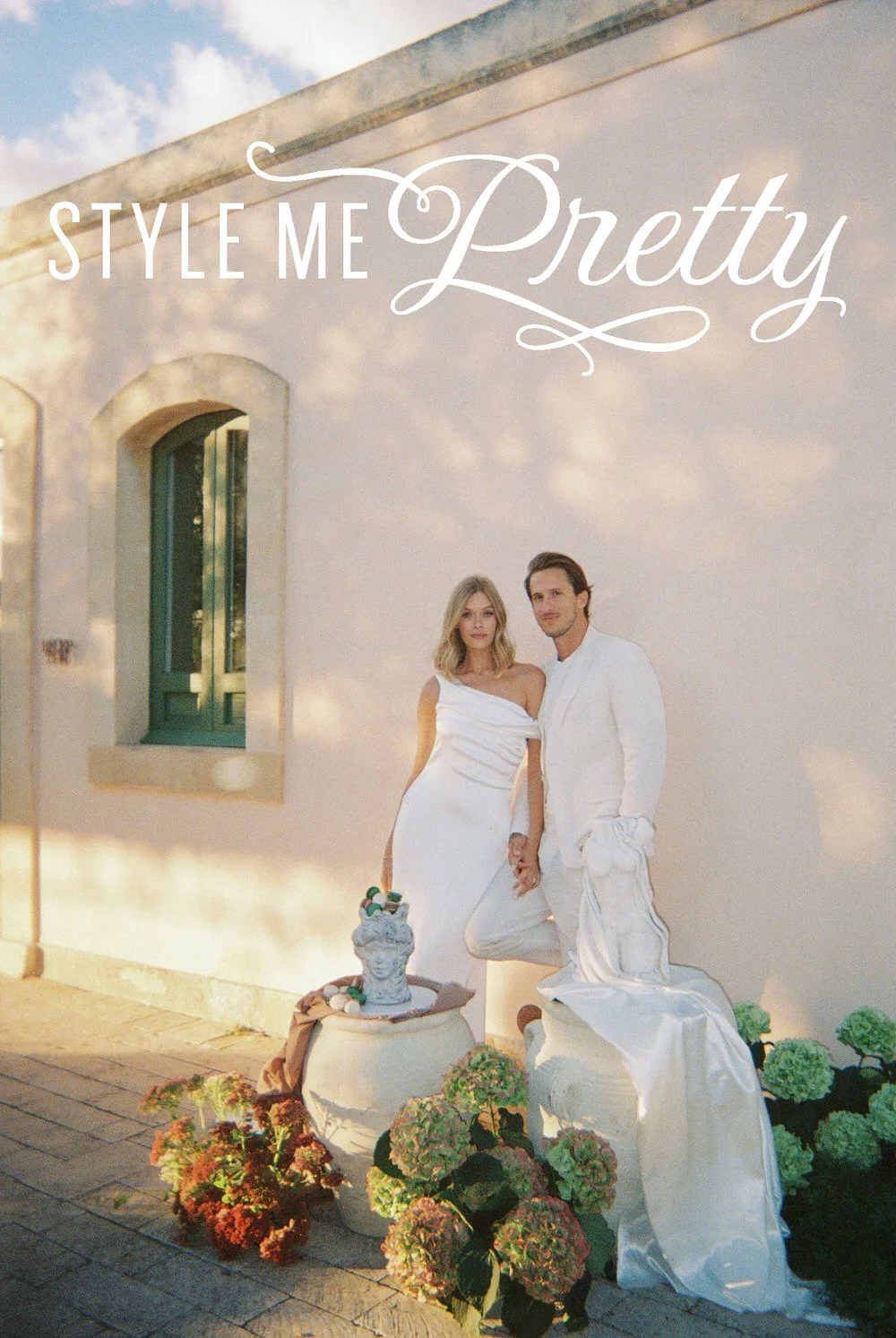 Braccialieri Sicily wedding editorial portrait of a couple in white holding hands against a sunlit Mediterranean villa wall, with soft shadows, sculptural florals and vintage ceramic details, captured on 35mm film with a warm, nostalgic and refined a
