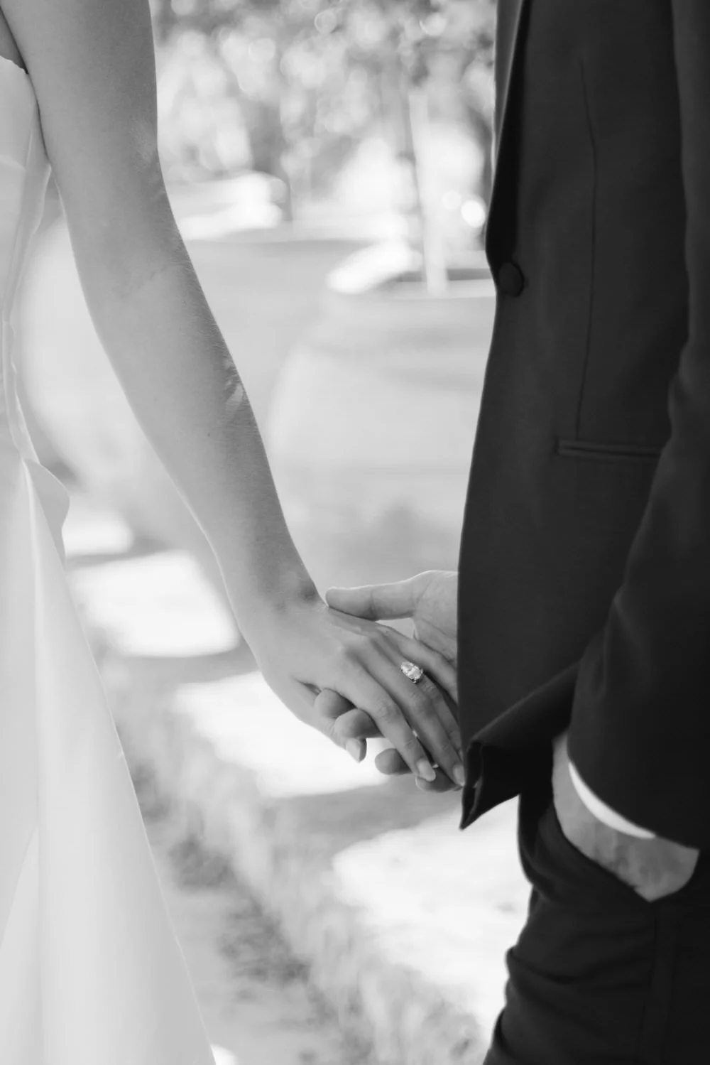 intimate moment at braccialieri, sicily wedding. close-up of the couple holding hands, with a soft focus on the engagement ring. emotional, editorial wedding photography for modern couples 