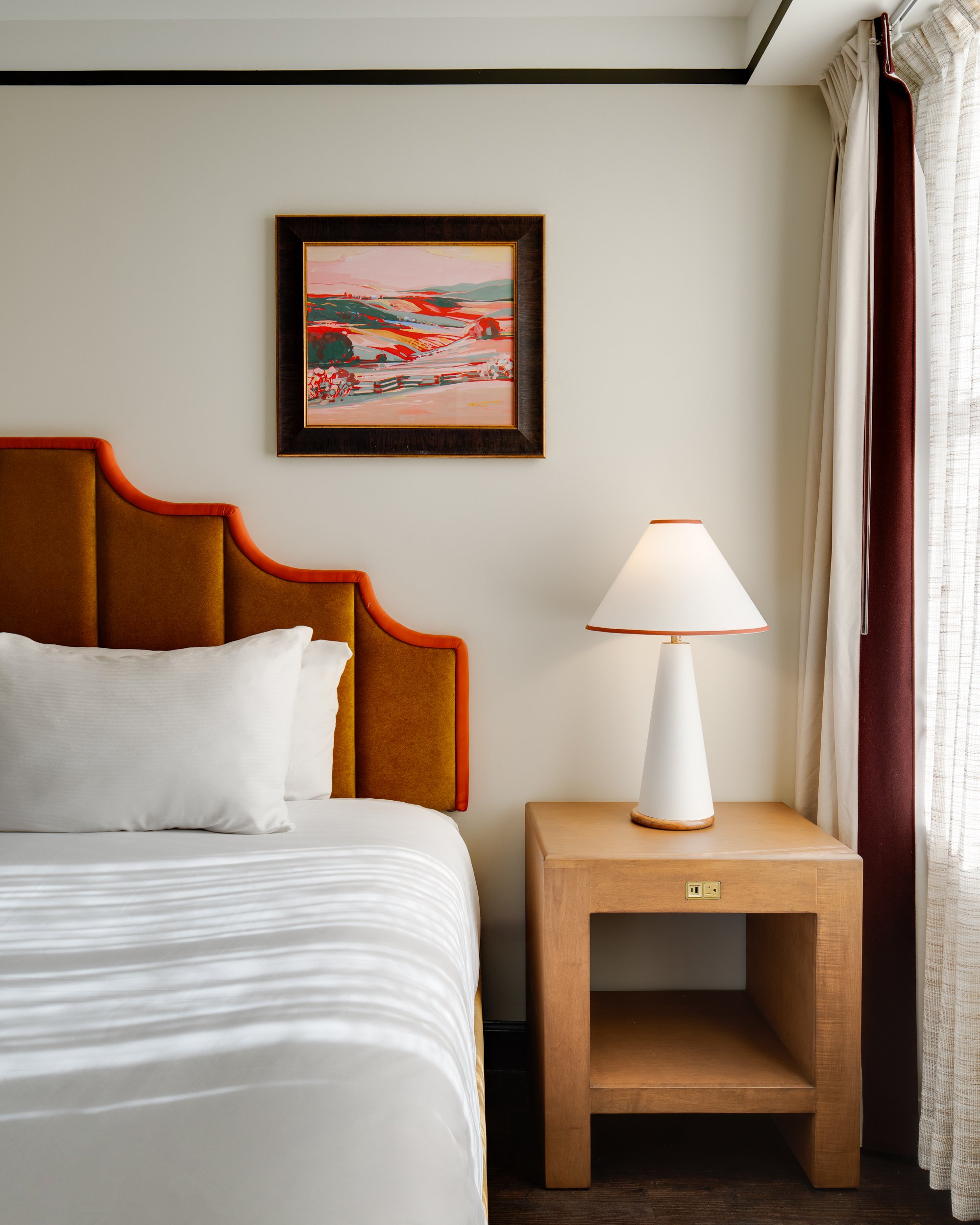 Modern hotel suite with clean lines, warm accent lighting, and a cozy layered atmosphere