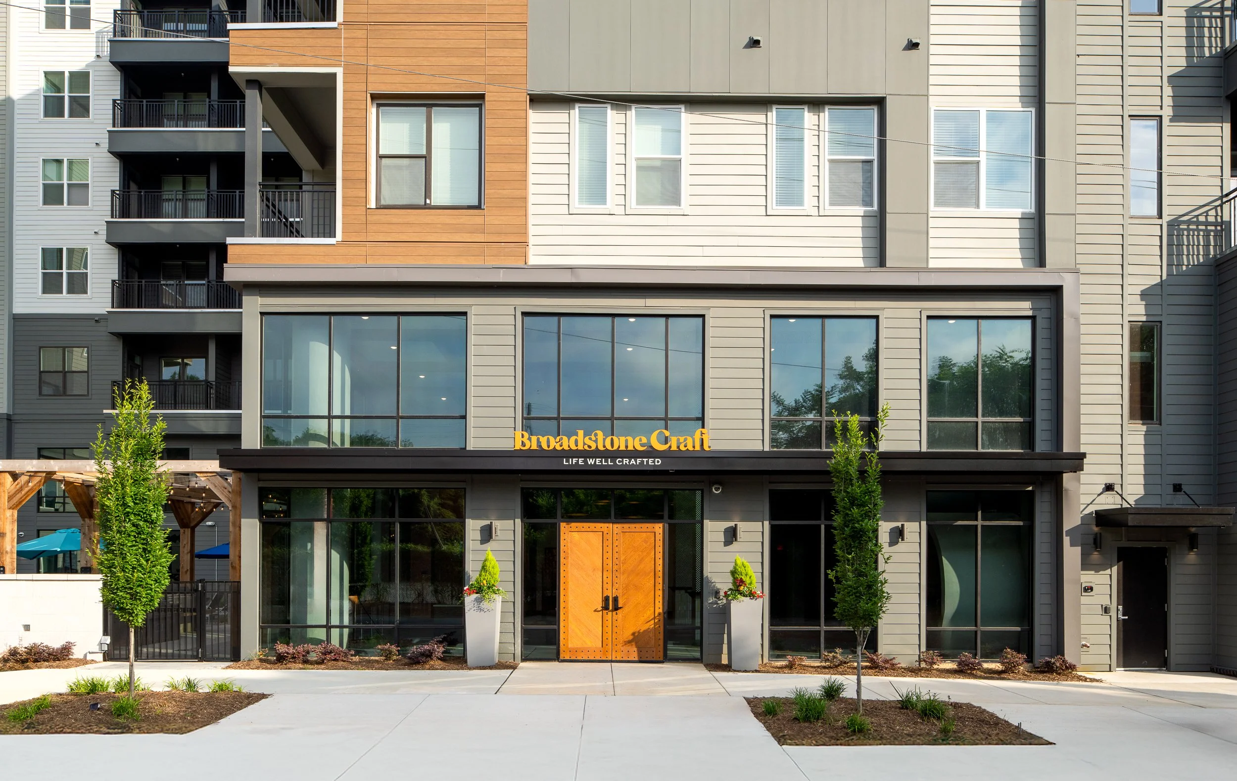 Main entrance of a modern residential building with wooden doors.