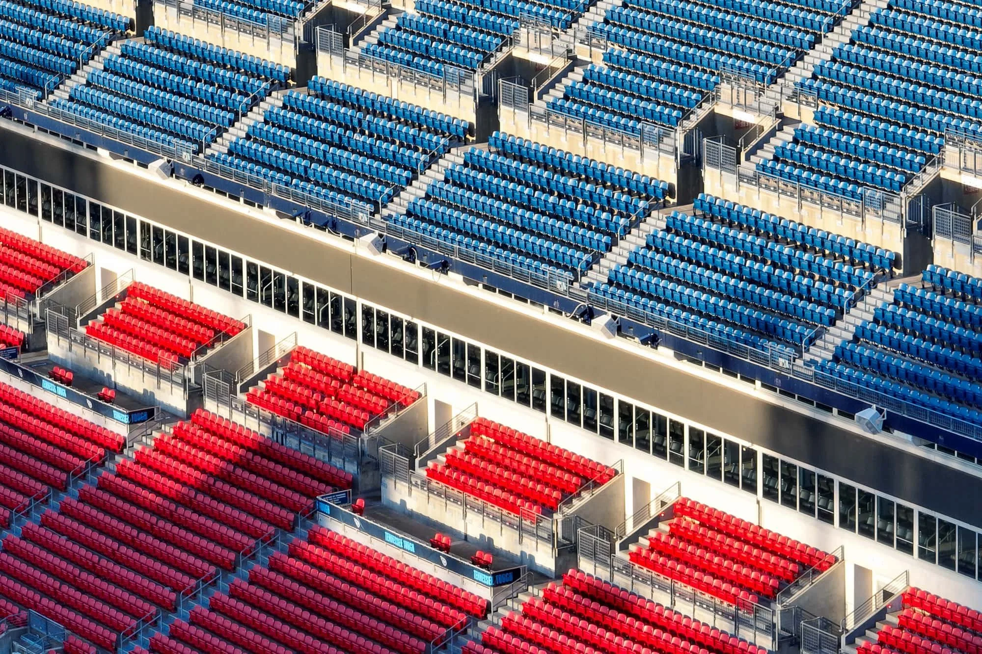 Close aerial view of Nissan Stadium seating sections showing the pattern of red and blue Tennessee Titans seats from above