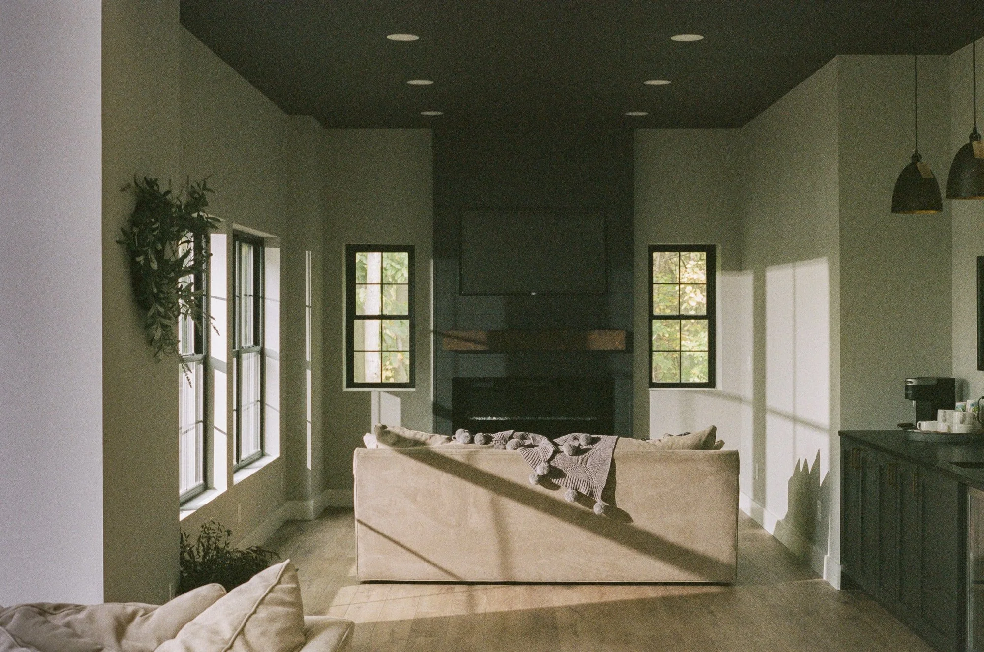 Sunlit living room with a stone fireplace, shot on 35mm film on a tripod without a cable release