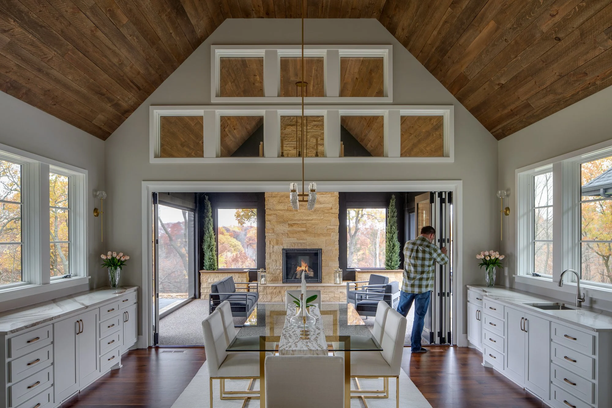 Dining space with an open-concept kitchen, white cabinets, and stylish decor.