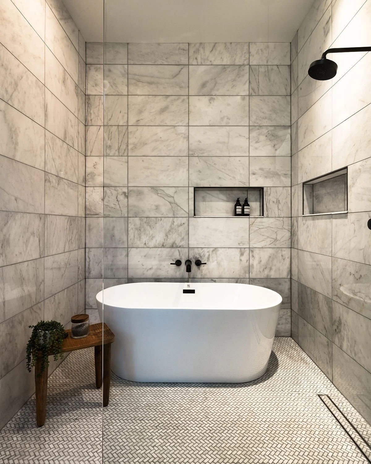 Luxury bathroom with white marble and freestanding tub.