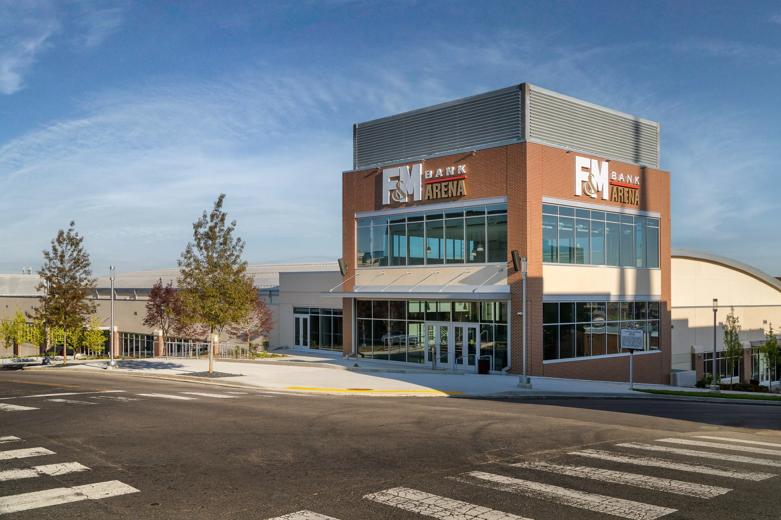 Arenas’ main entryway featuring reflective glass panels and brick accents.