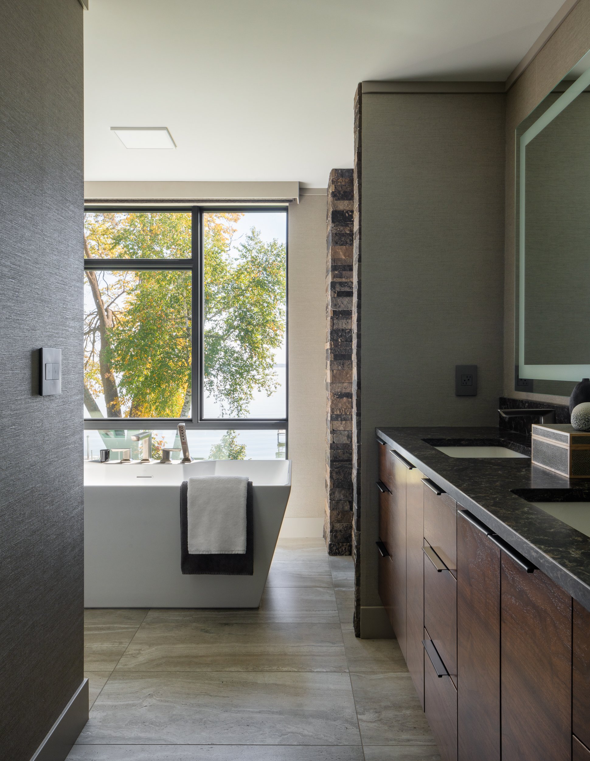 Modern powder room with statement lighting and wood cabinetry.