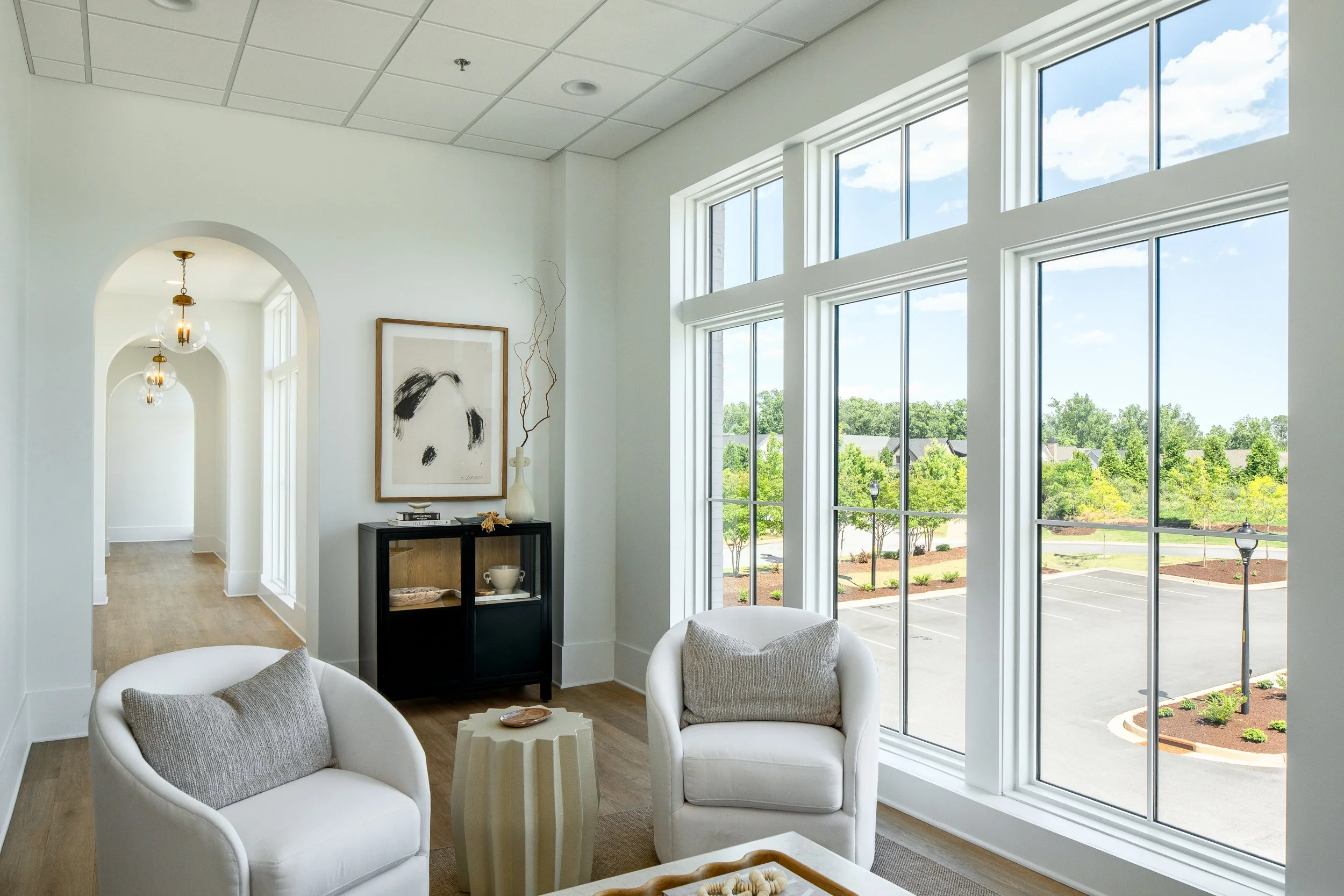 Bright lounge with large windows and contemporary furniture.