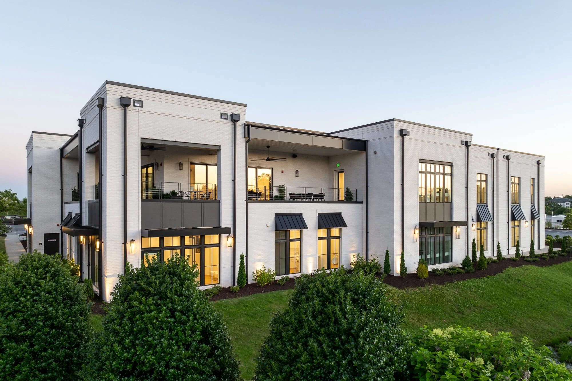Two-story healthcare building with modern design and outdoor balconies.
